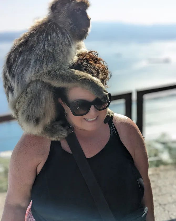 Travel advisor posing with a monkey
