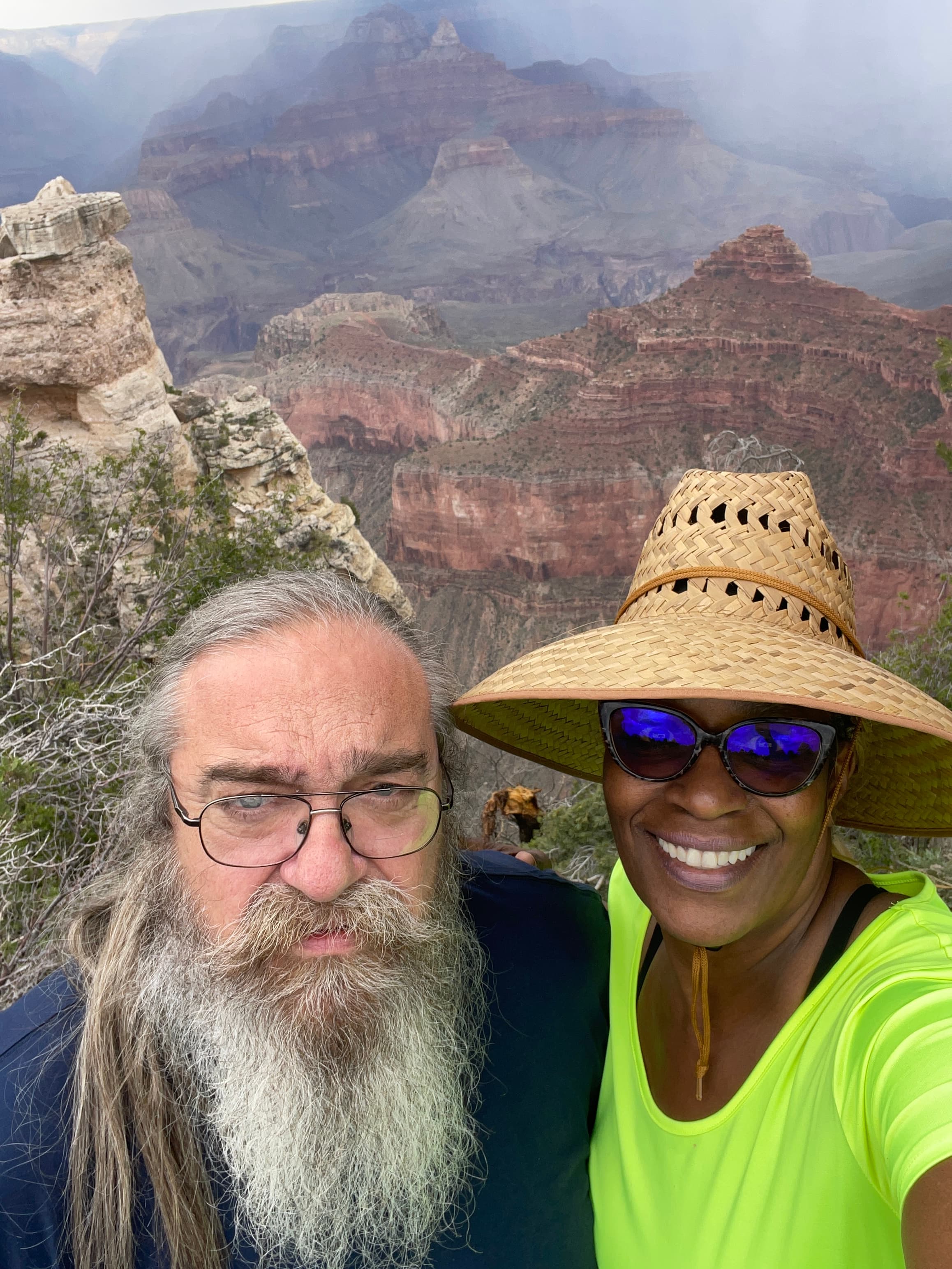 Advisor taking a selfie in the mountains beside a man with a large beard