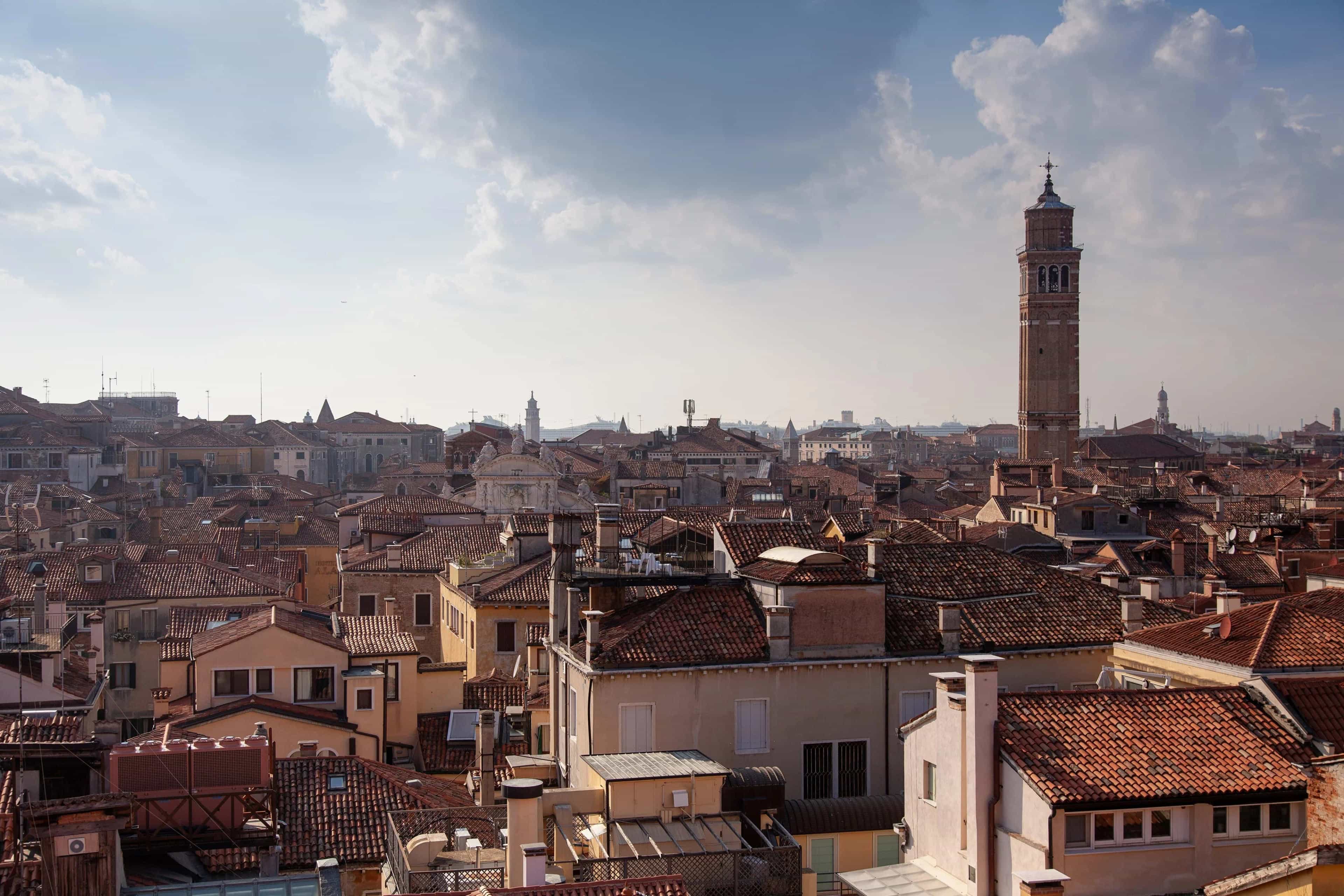 view of brown rooftops of ancient city and tower during day