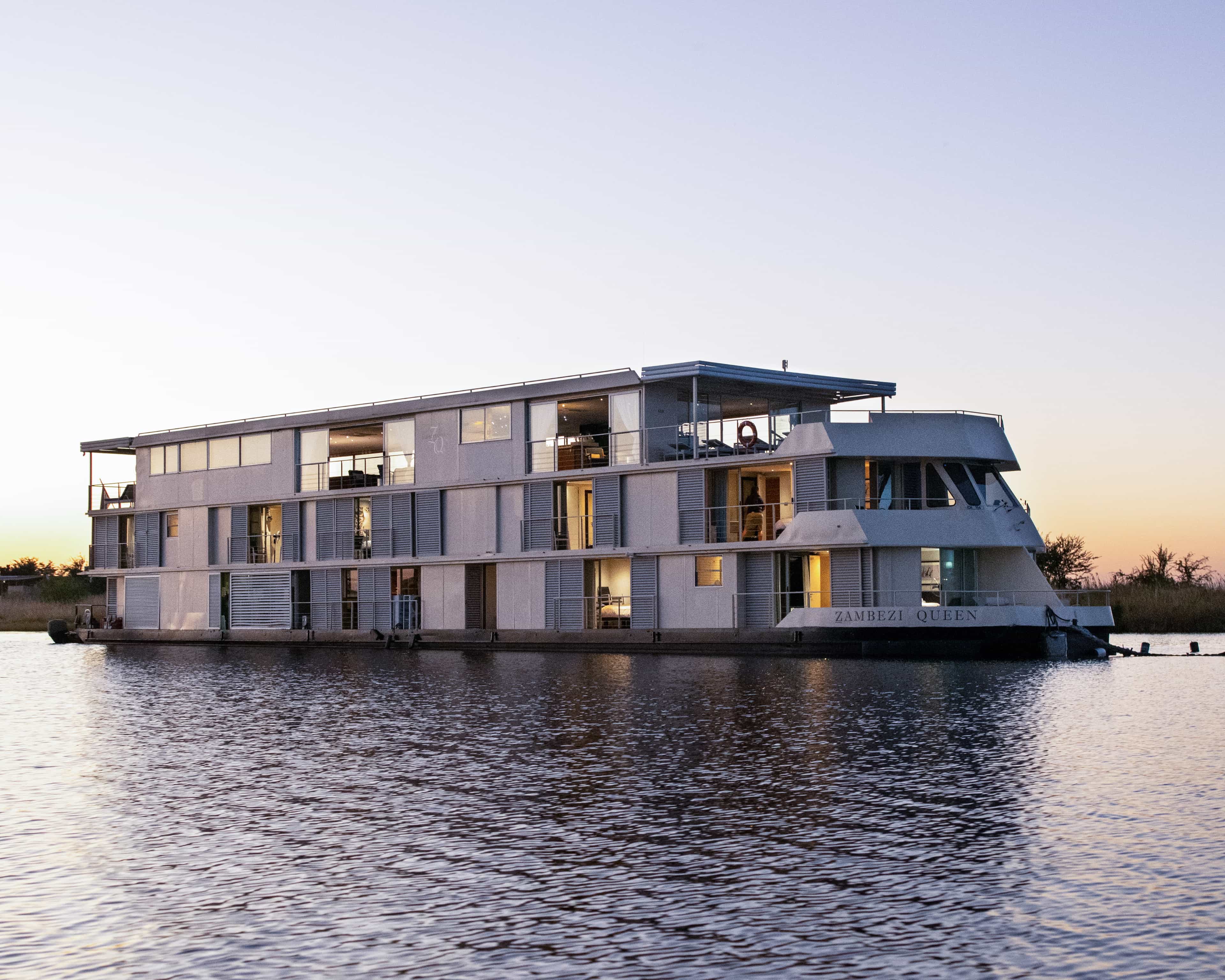 a modern river cruise boat on calm waters at dusk