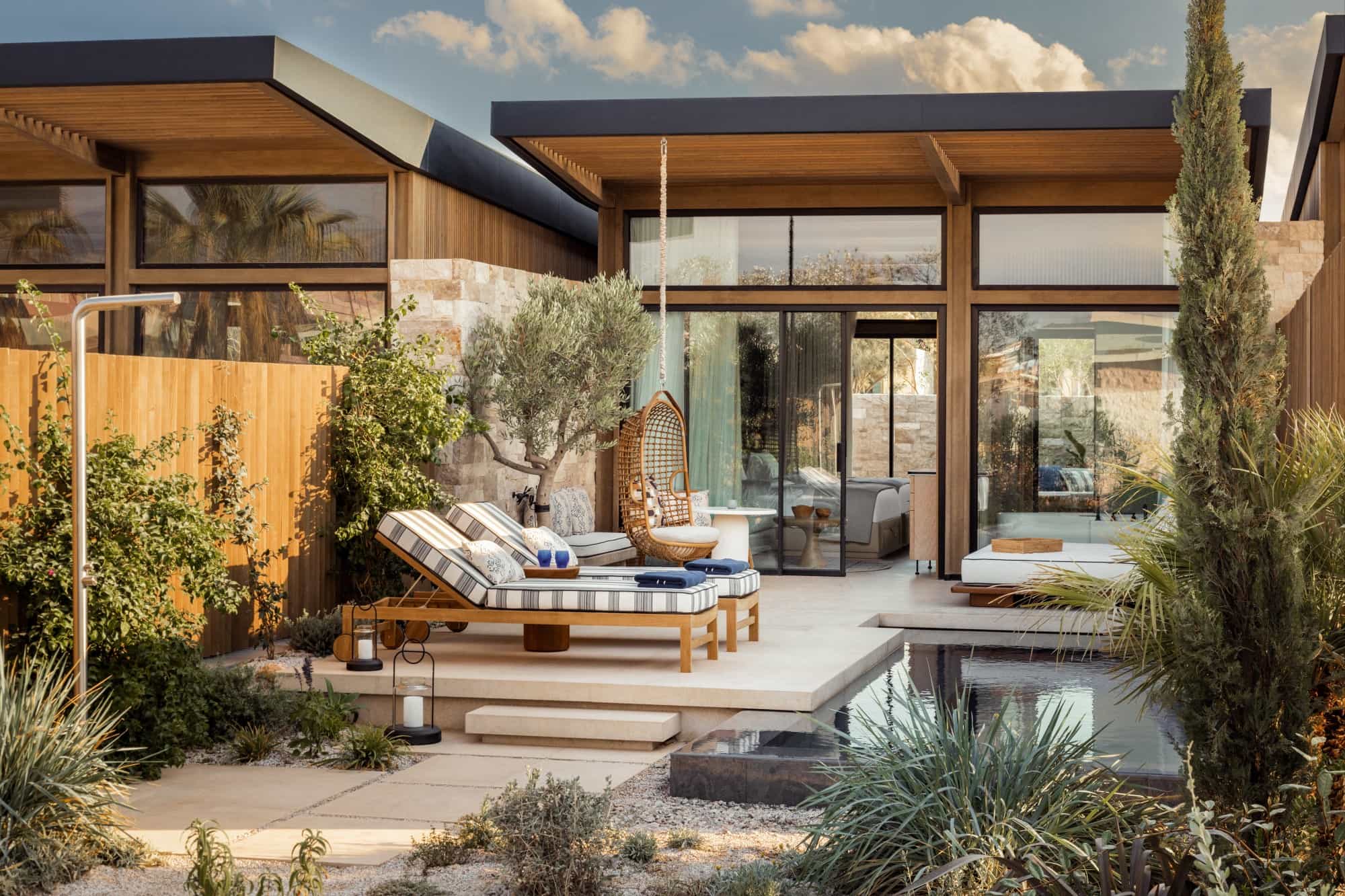 a luxe outdoor courtyard of a modern home with a sleek pool