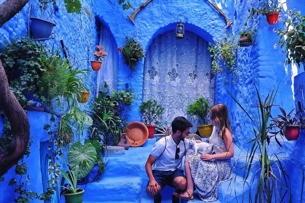 a-couple-sitting-in-blue-city-morroco-travel-guide