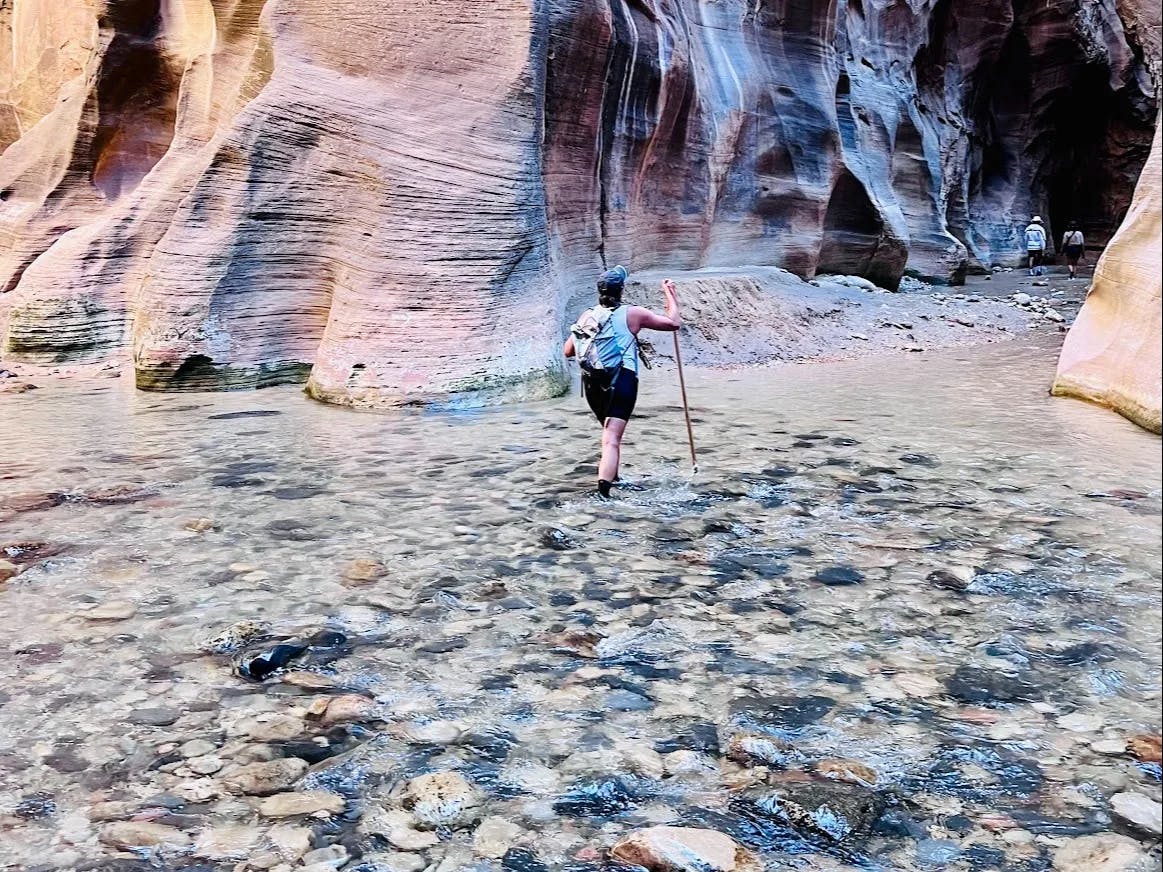 A person hiking through water. 