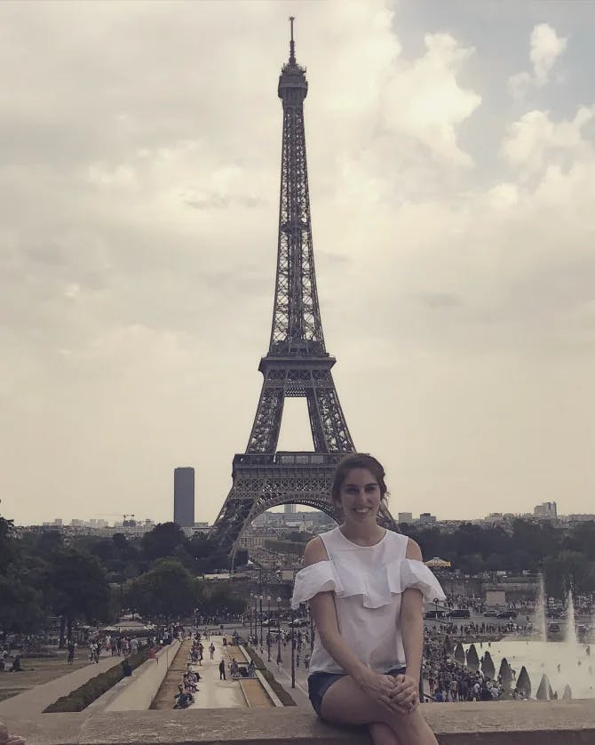 Travel advisor posing in front of Eiffel Tower
