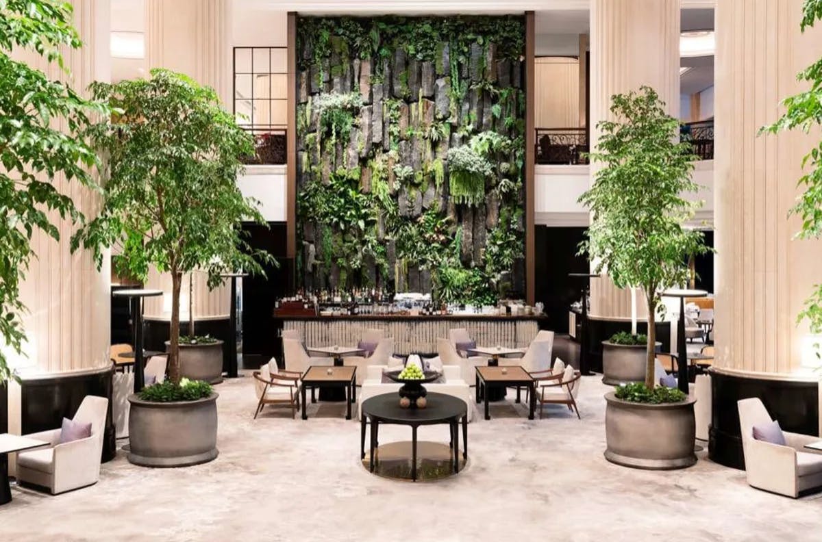The lobby of the Shangri-La Singapore, with a large plant installation and trees.