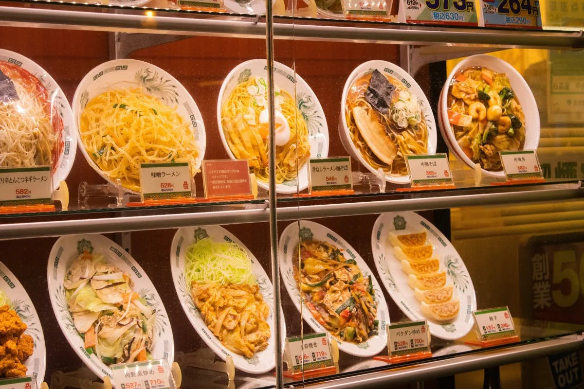 A display case filled with various Japanese dishes.