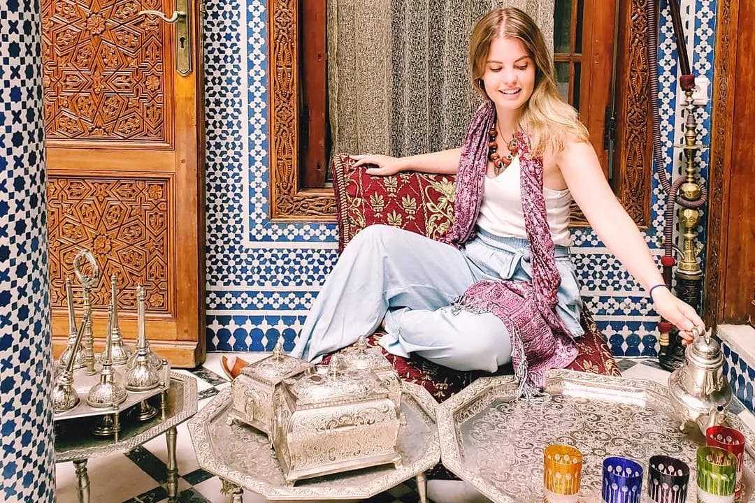 girl-sitting-cultural-artifacts-morocco-travel-guide