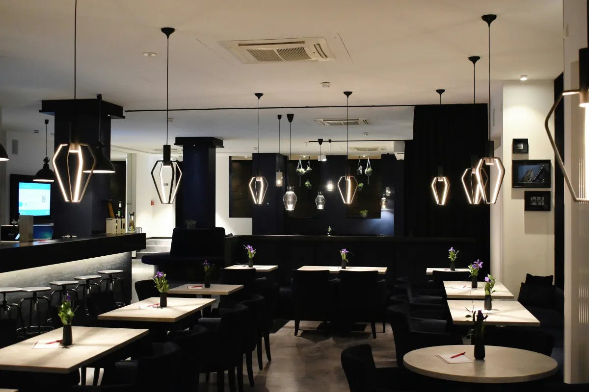 A picture of interior of a restaurant with black and white aesthetics.