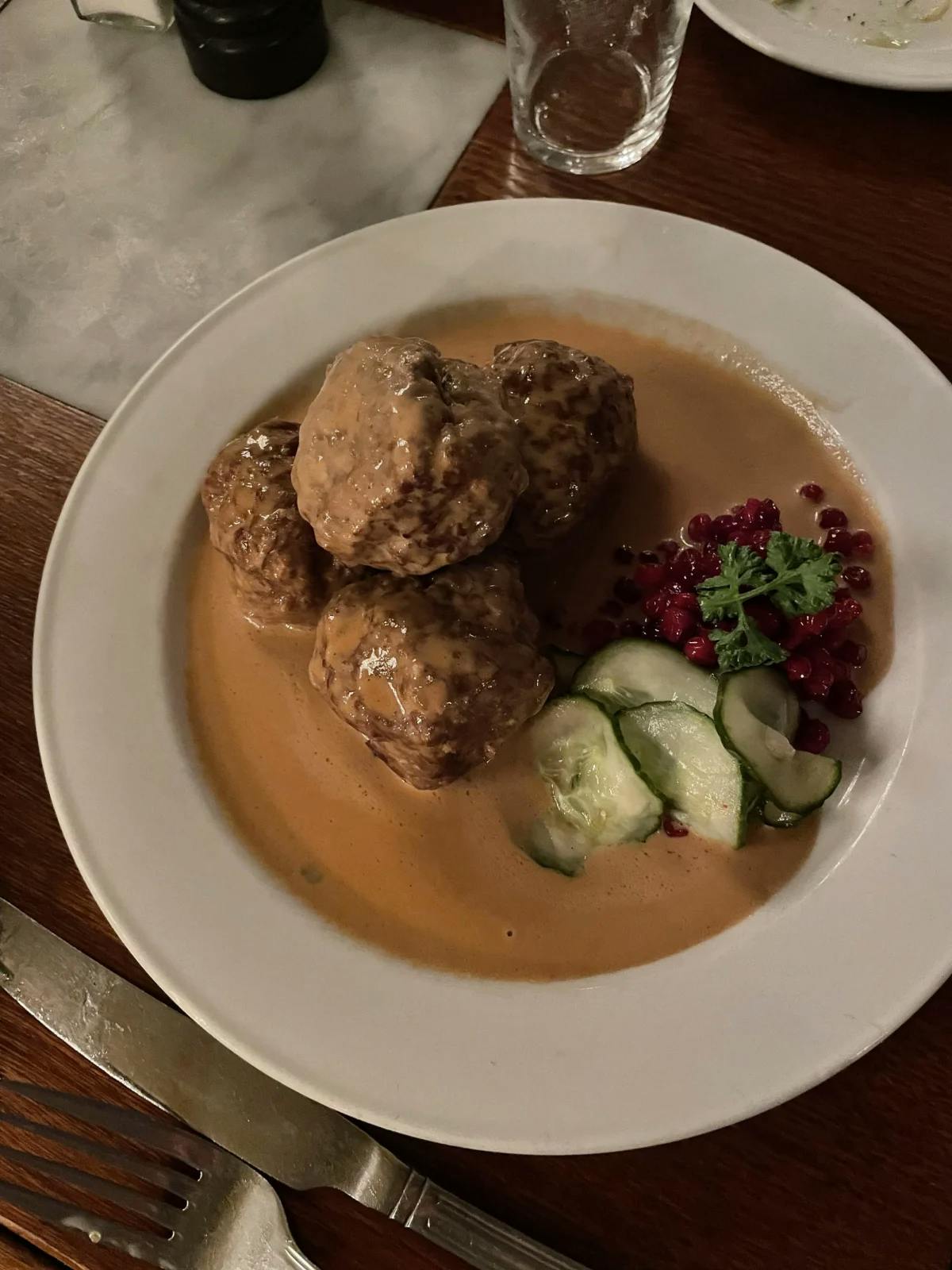 Meatballs in a sauce on a white plate