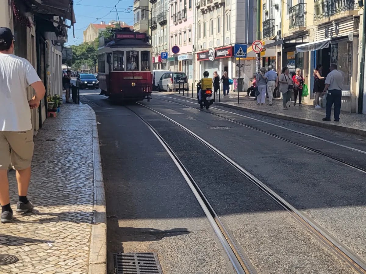 A tram on a street in city during day time.