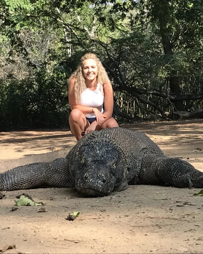 Travel advisor posing with an alligator