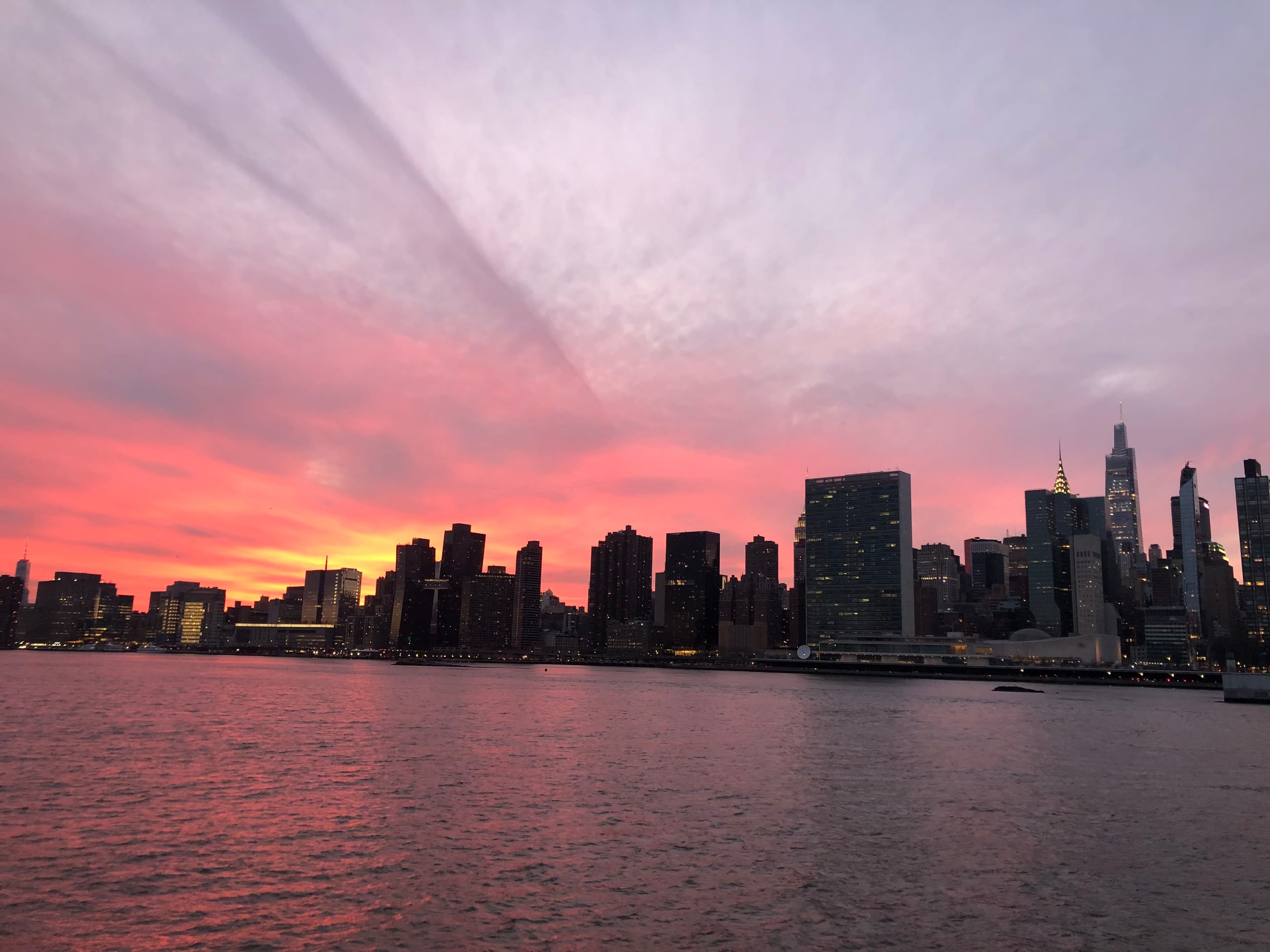 Beautiful view of the New York City skyline under a pink and purple sunset