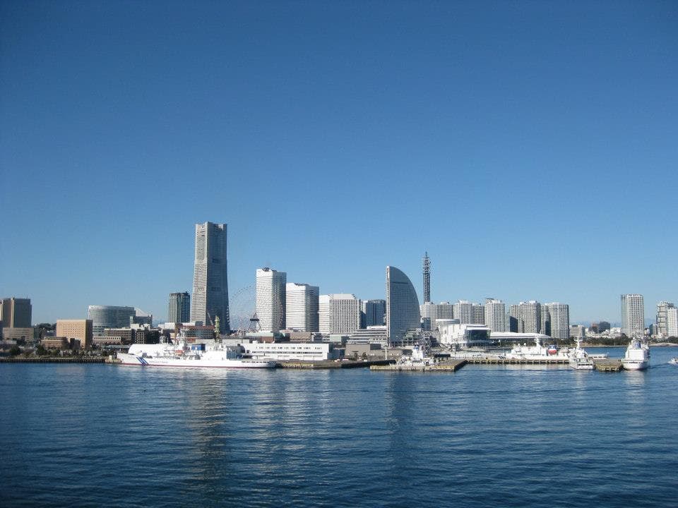 View of a modern city skyline along the water on a clear day
