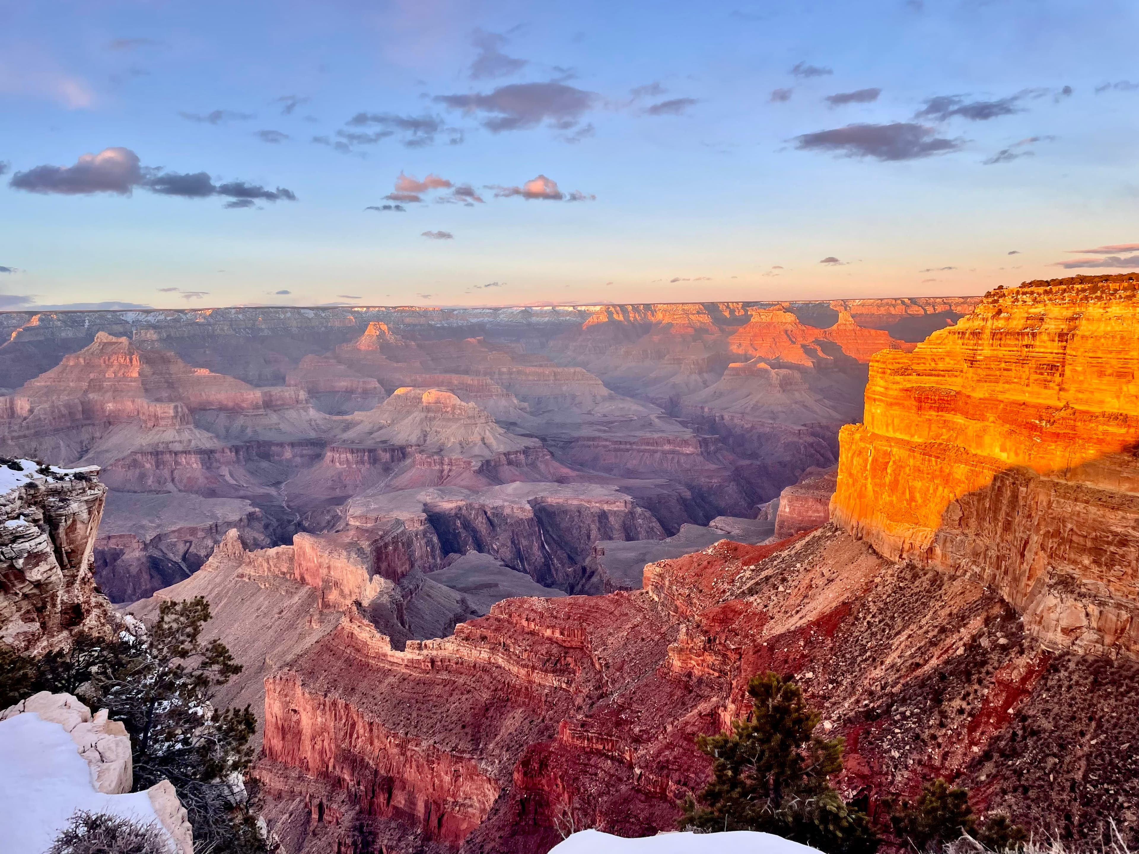 beautiful view of mountains and canyons glowing in an orange sunrise