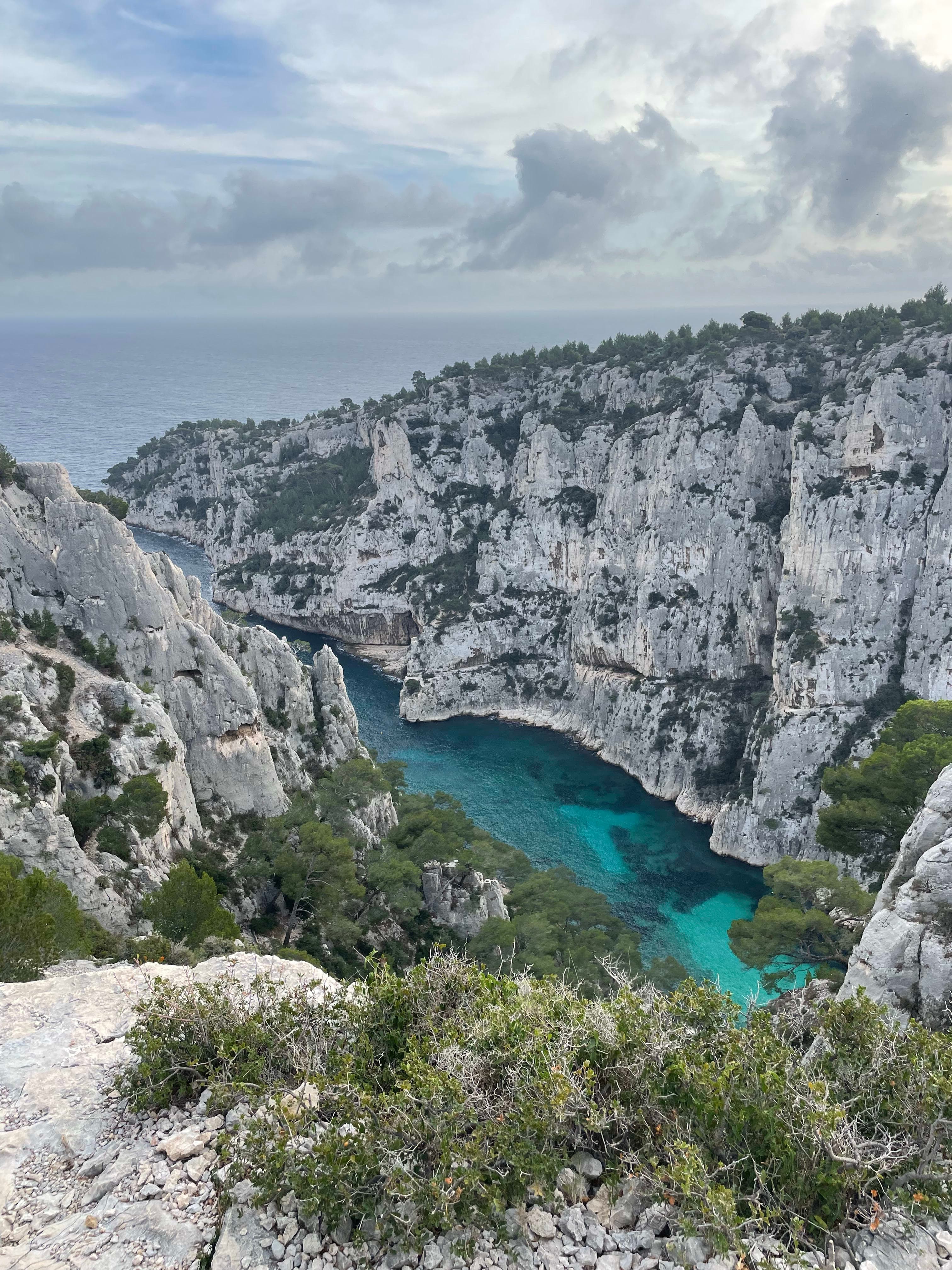  beautiful view of a gorge with a bright blue river running through in calanques national park