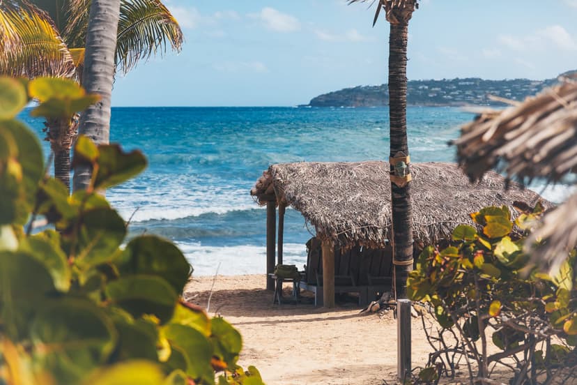 two chairs on a wooden deck overlooking the sea