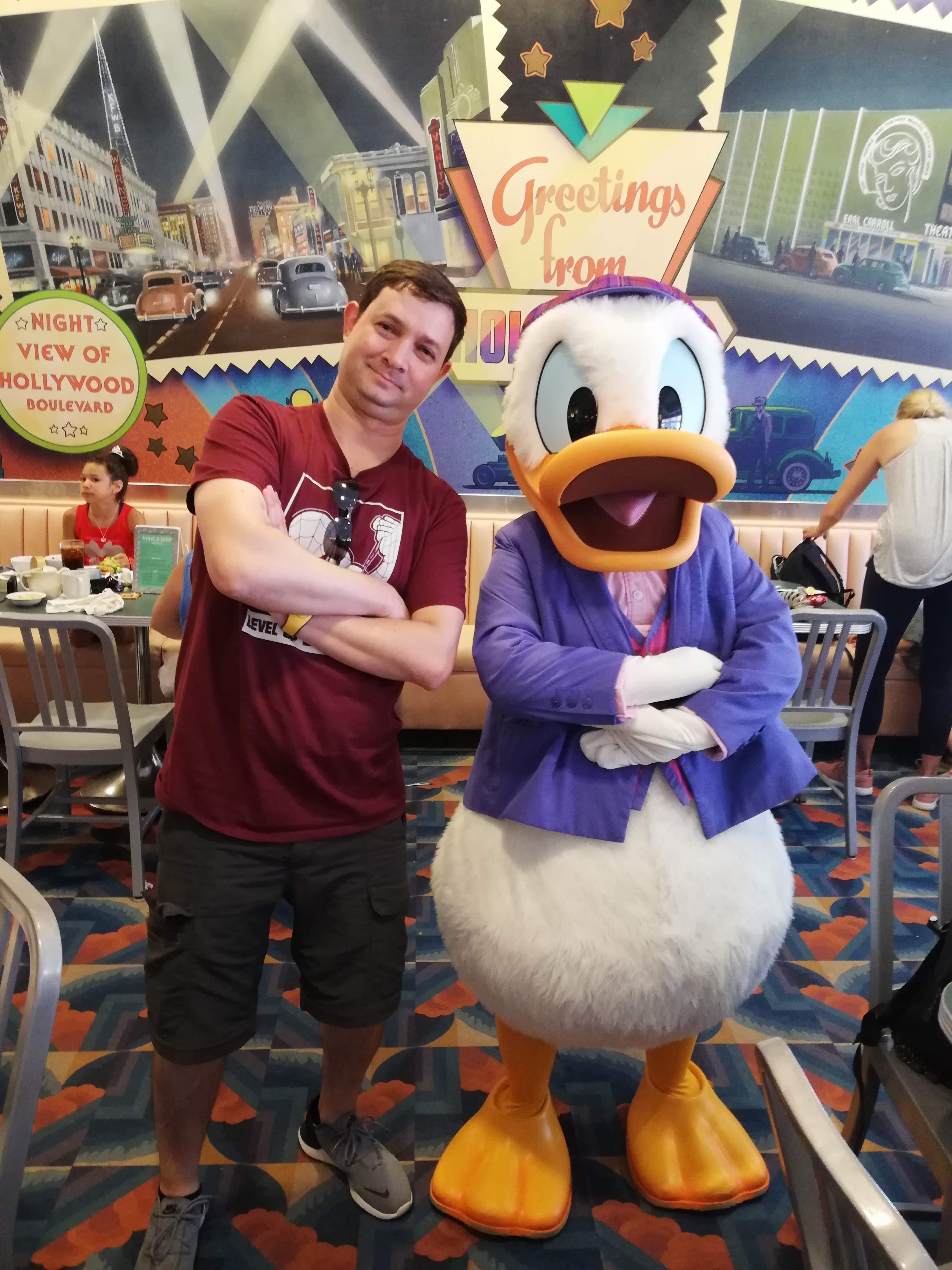 Advisor posing with Donal Duck at Disney.