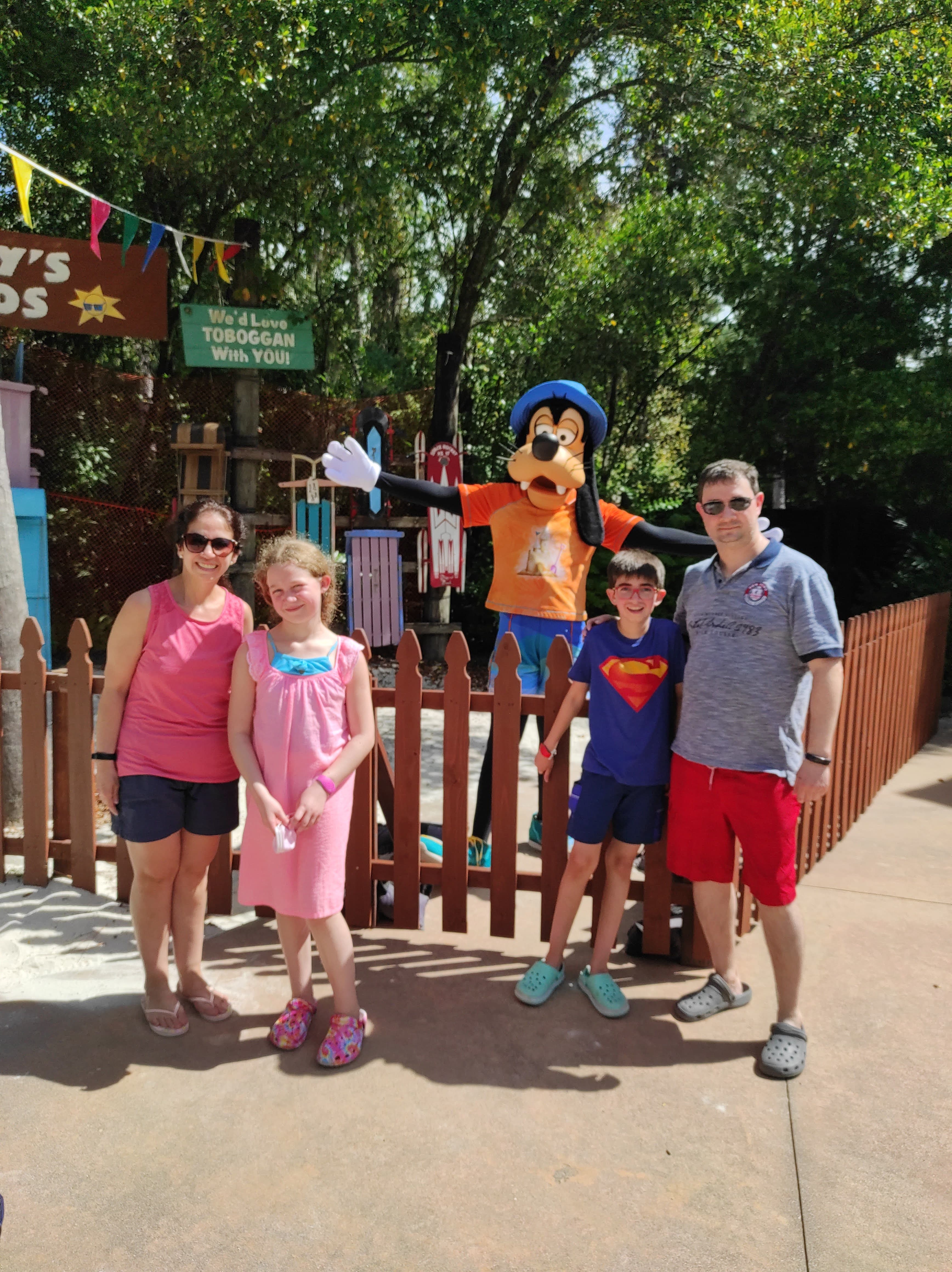 Advisor posing with his children at Disney. 