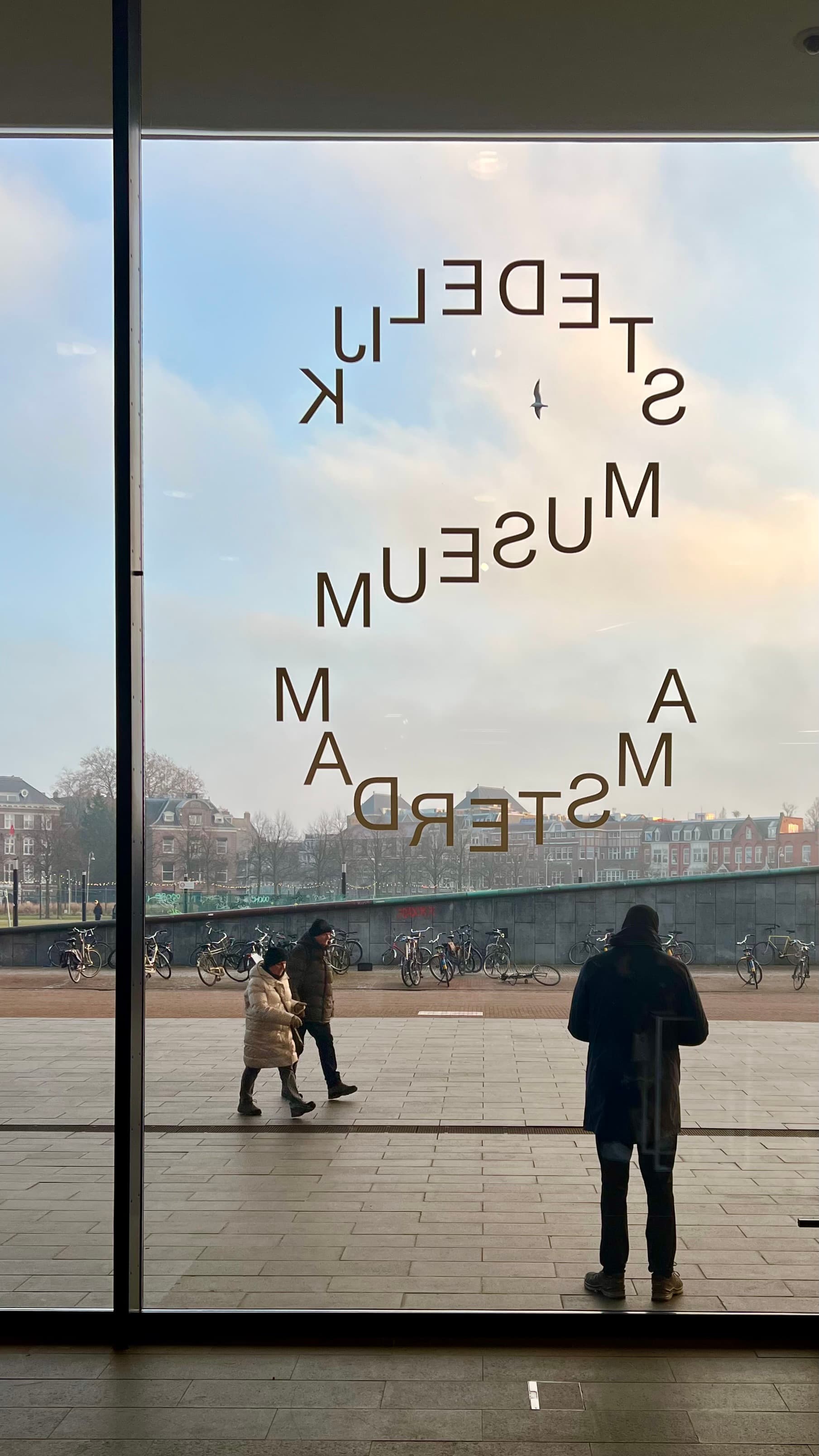Imagine from the inside of the Stedelijk Museum in Amsterdam looking out glass windows 