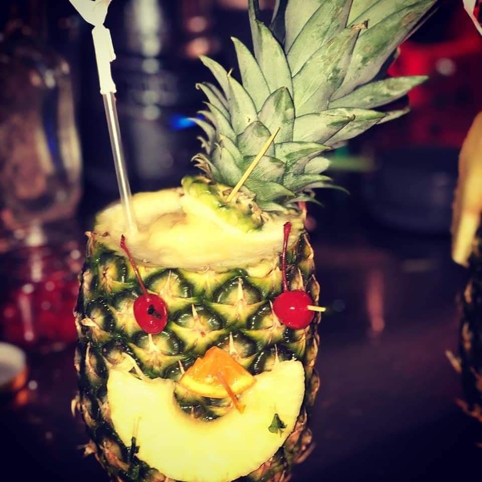 A pineapple dessert with fruit. 