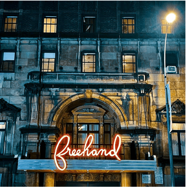 An image outside of the Freehand hotel with a classic style neon sign.