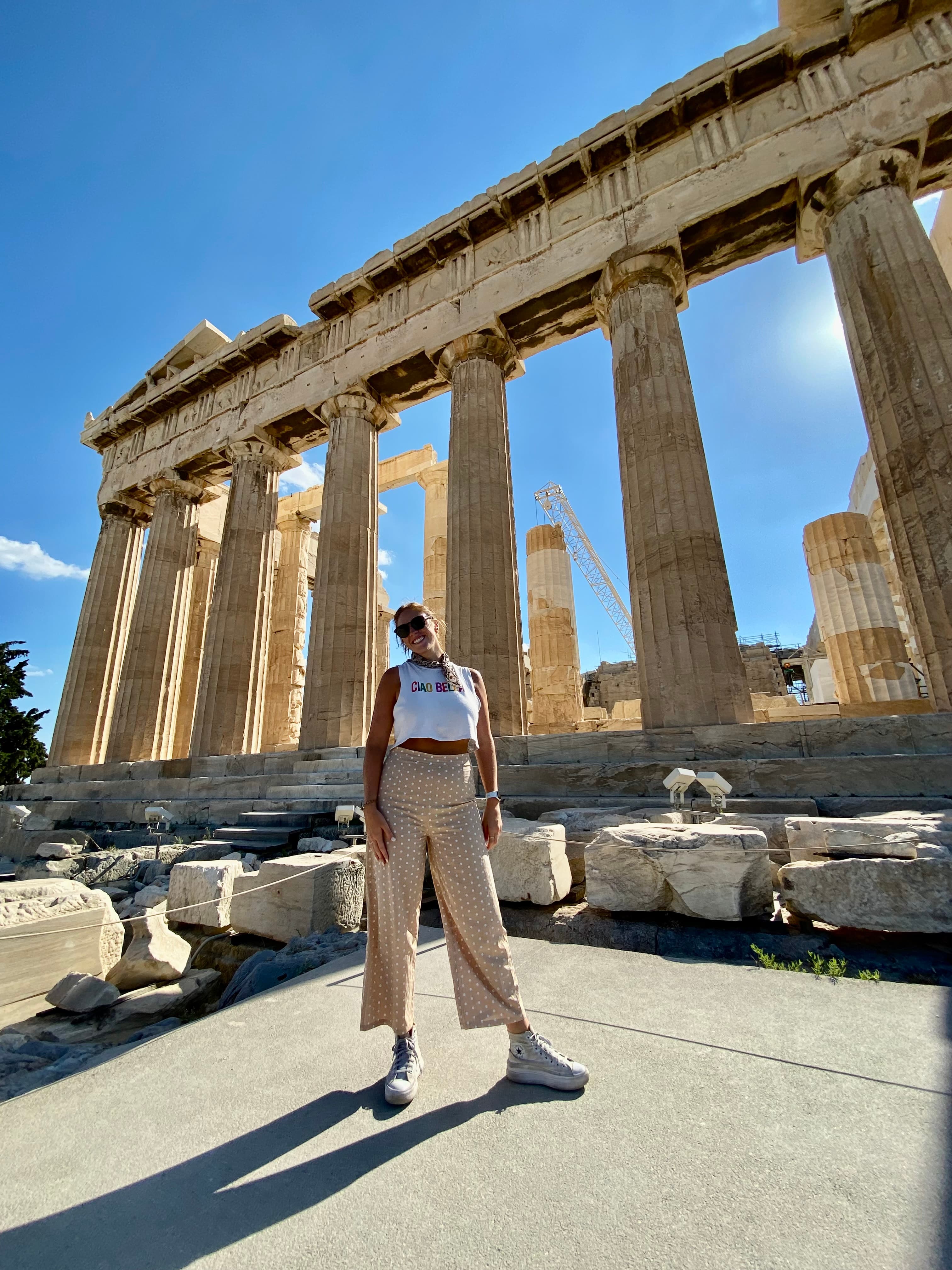 Advisor posing in front of ancient ruins on a sunny day.