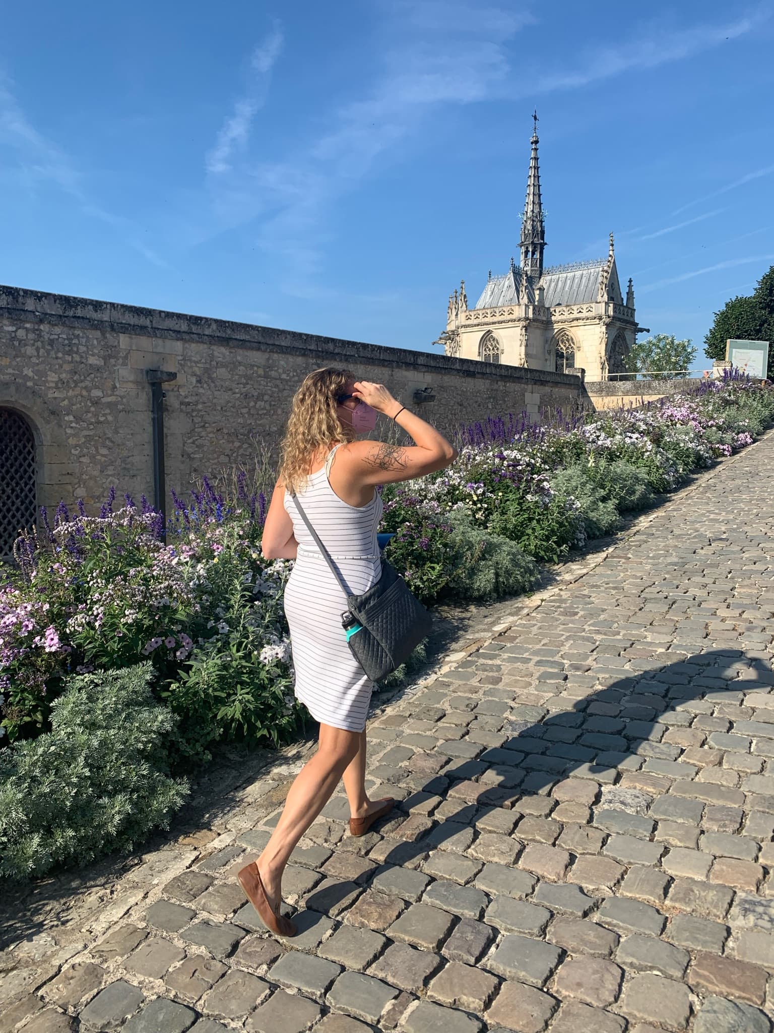 Advisor walking along cobblestone road on a sunny day. 