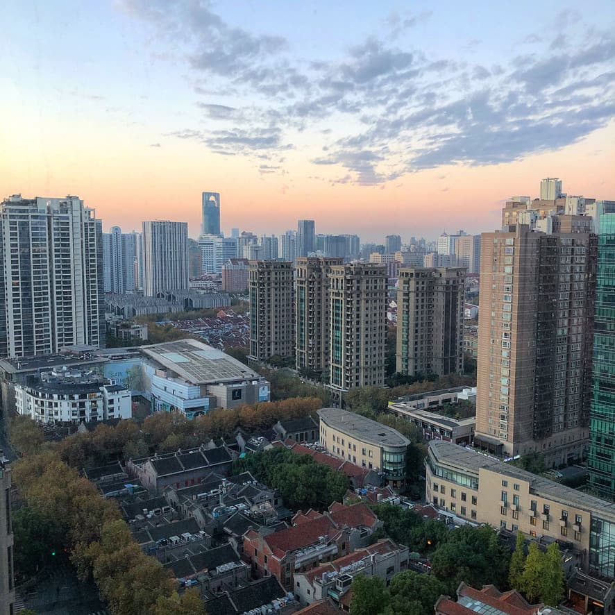 View of the Shanghai skyline full of high-rise buildings at sunset