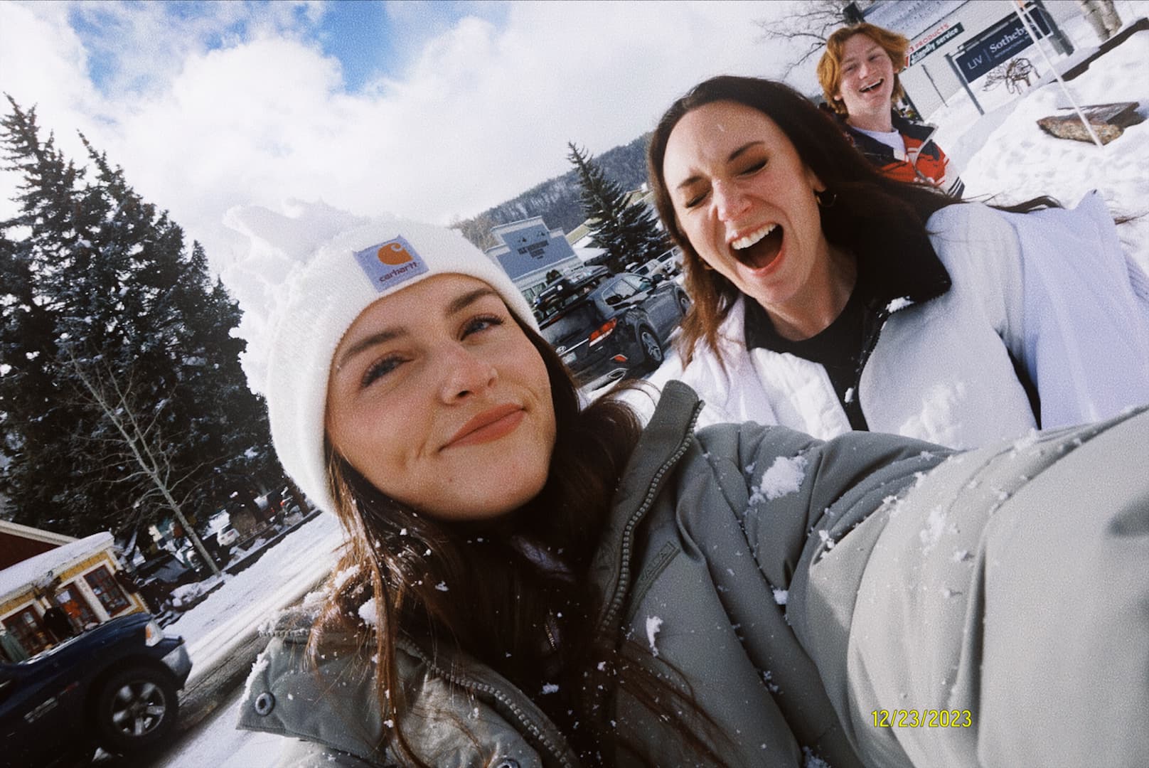 Advisor posing in front of a snow capped mountain scene on a sunny day. 