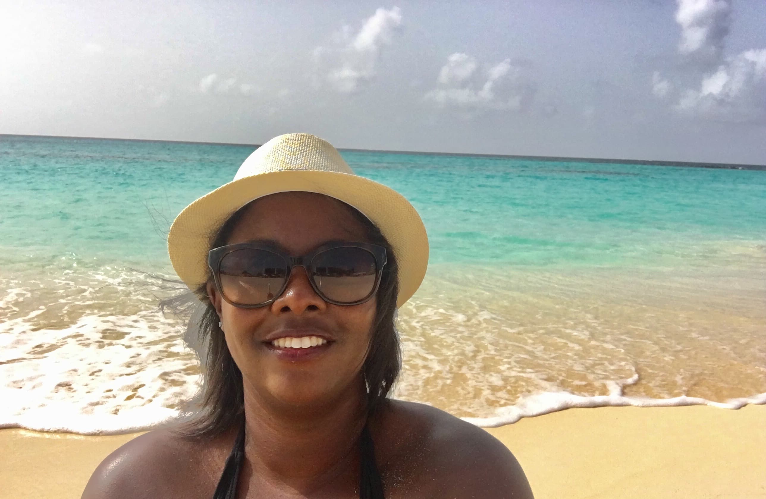 Selfie of advisor with water and beach in the background.