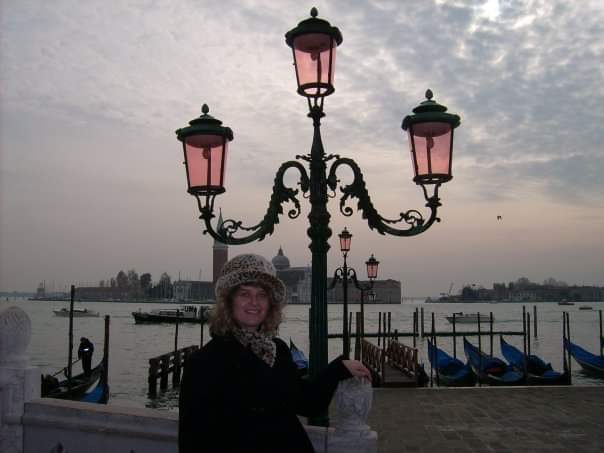 Standing by an old street light.