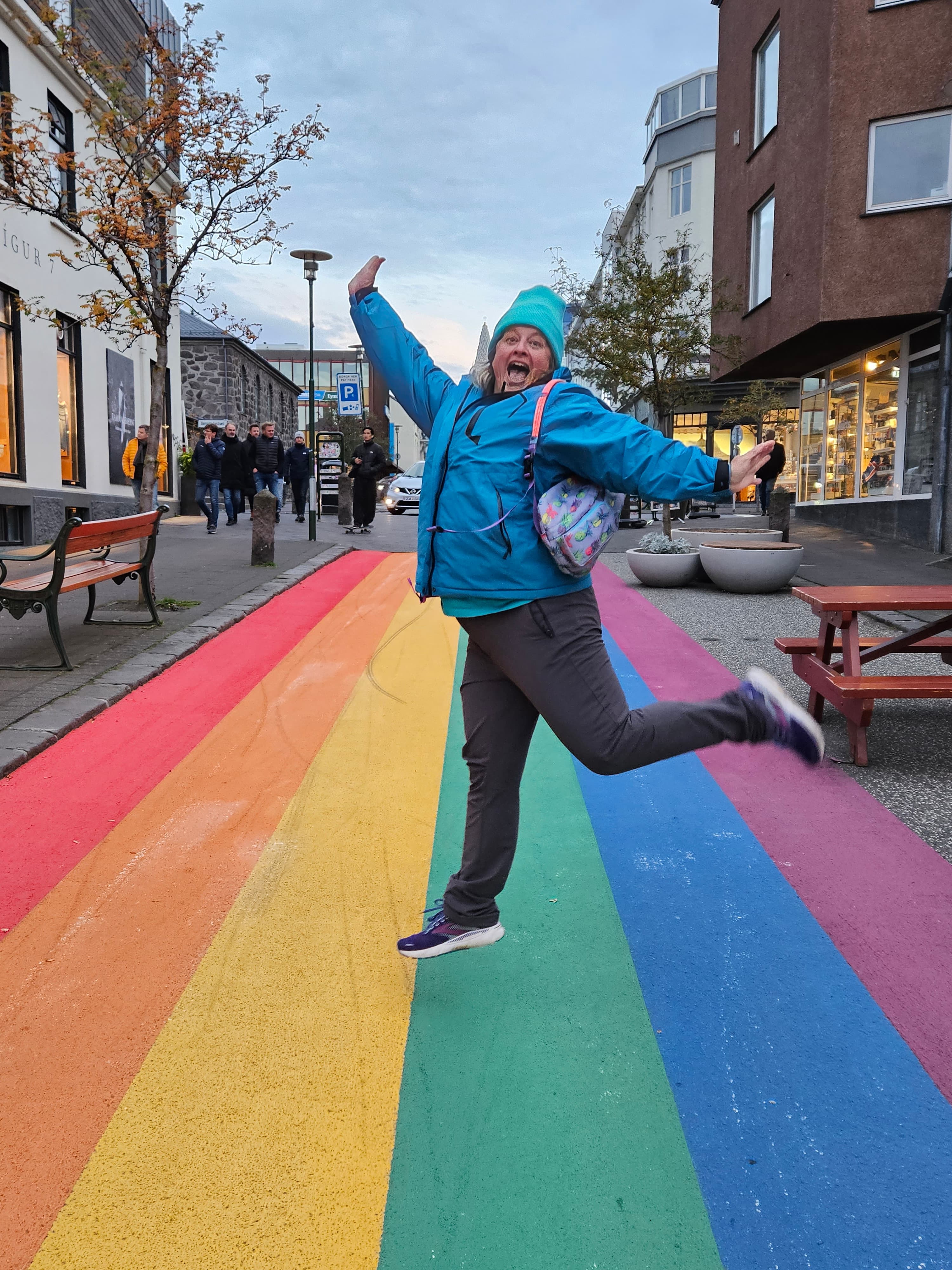 Walking across a rainbow crossing.