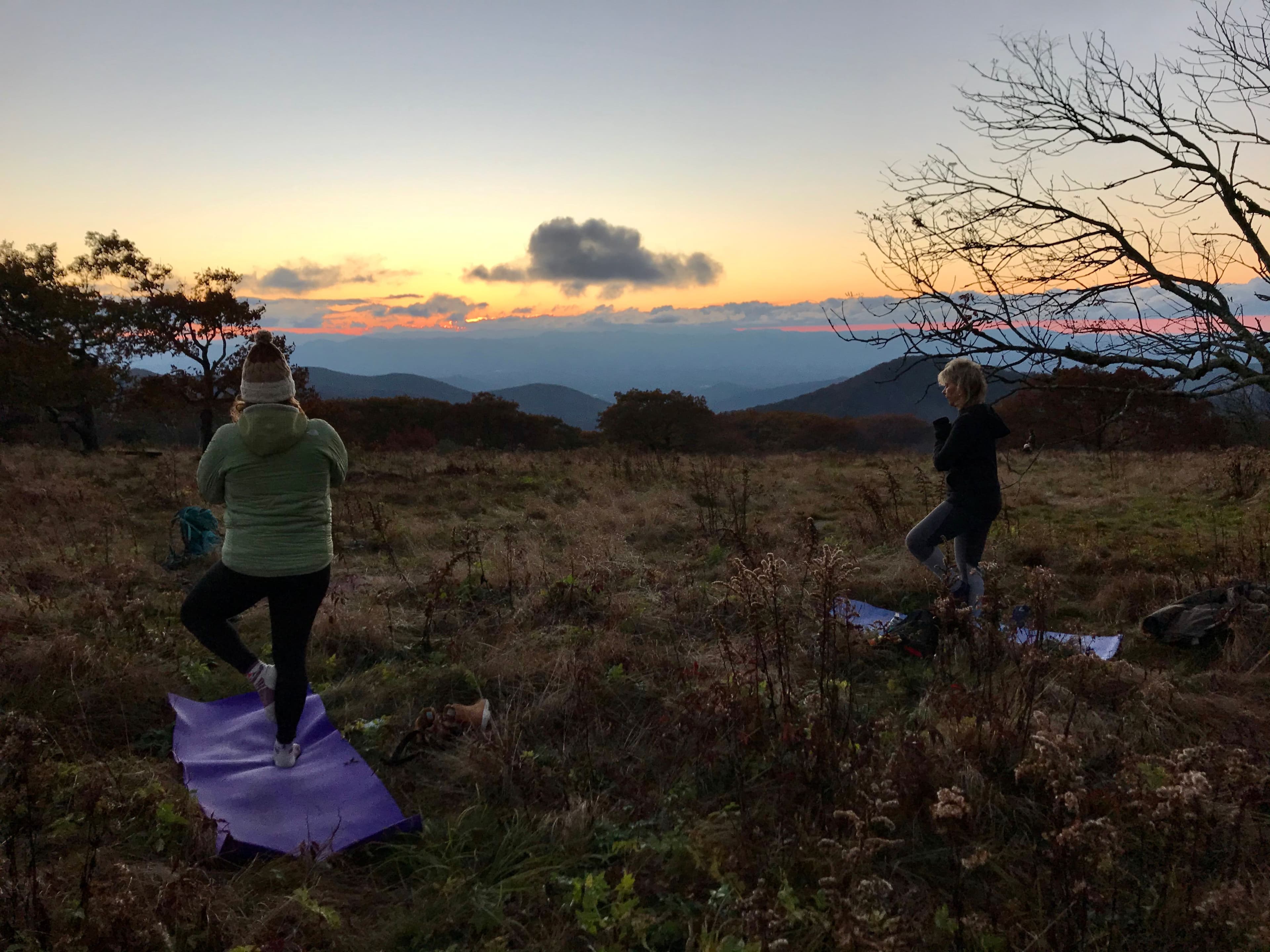 A woman posing in the desert at dusk. 