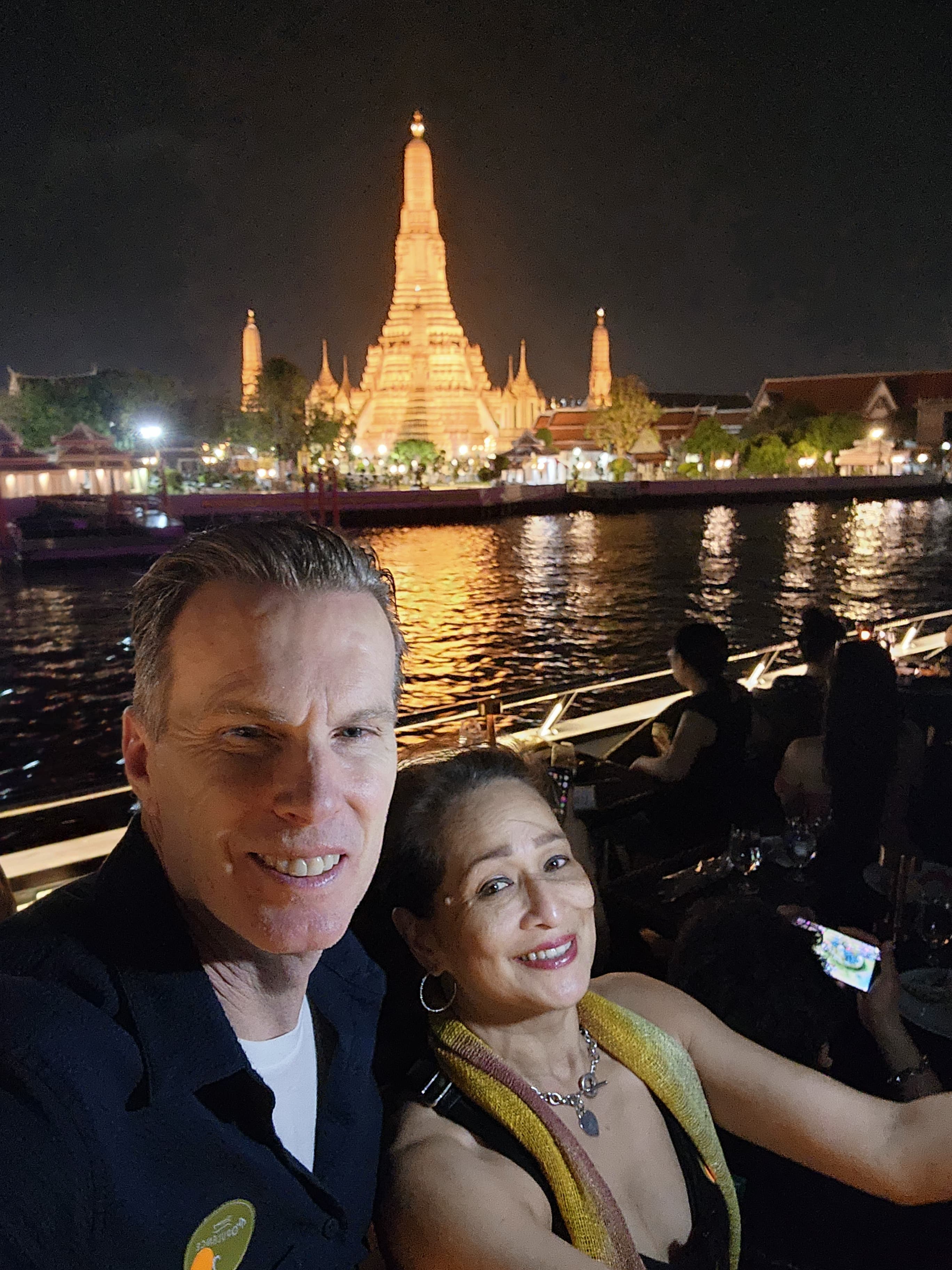 Advisor and partner posing in front of the Eiffel Tower during the nighttime.