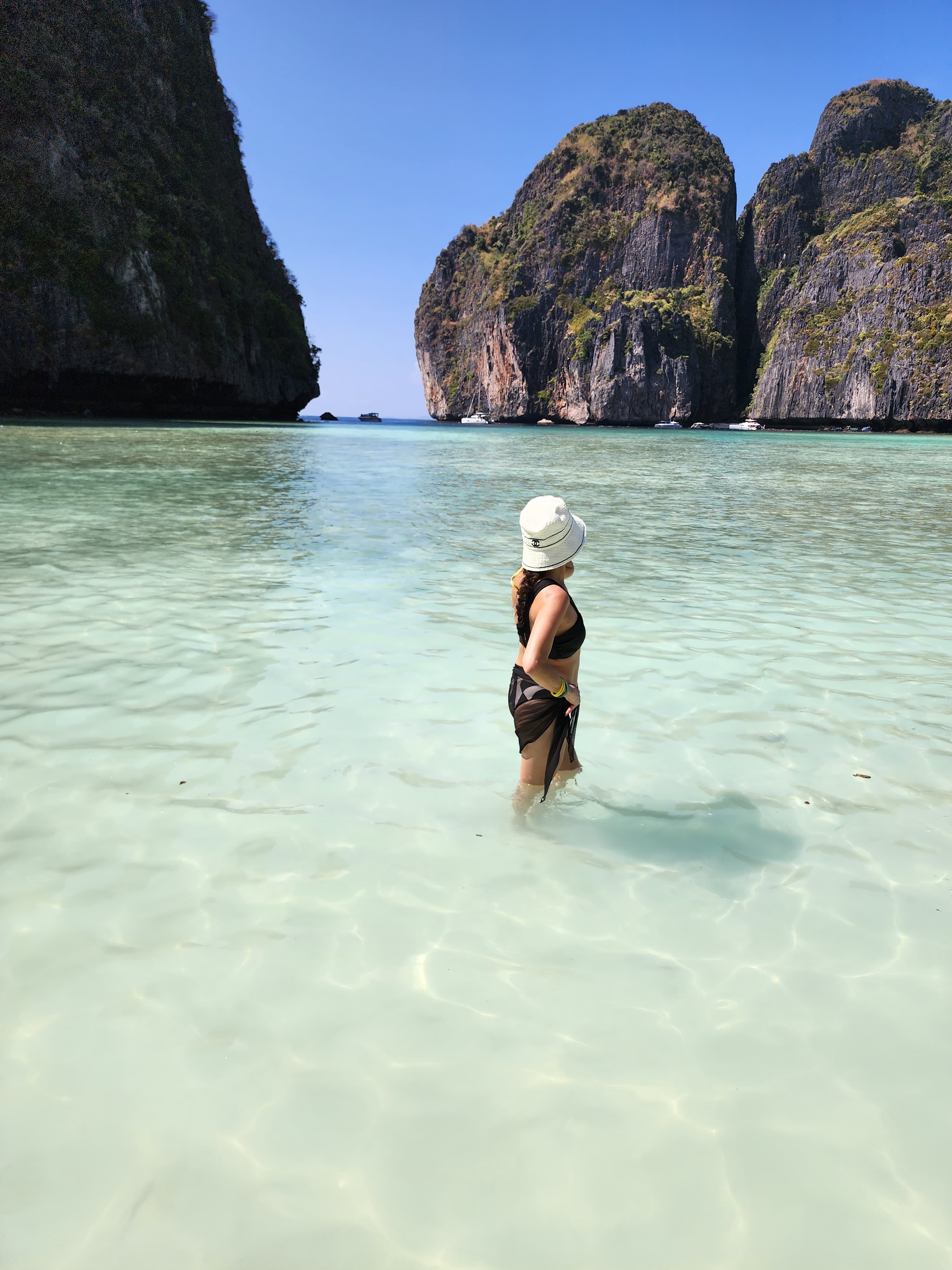 Advisor standing in the water at the beach during the daytime.