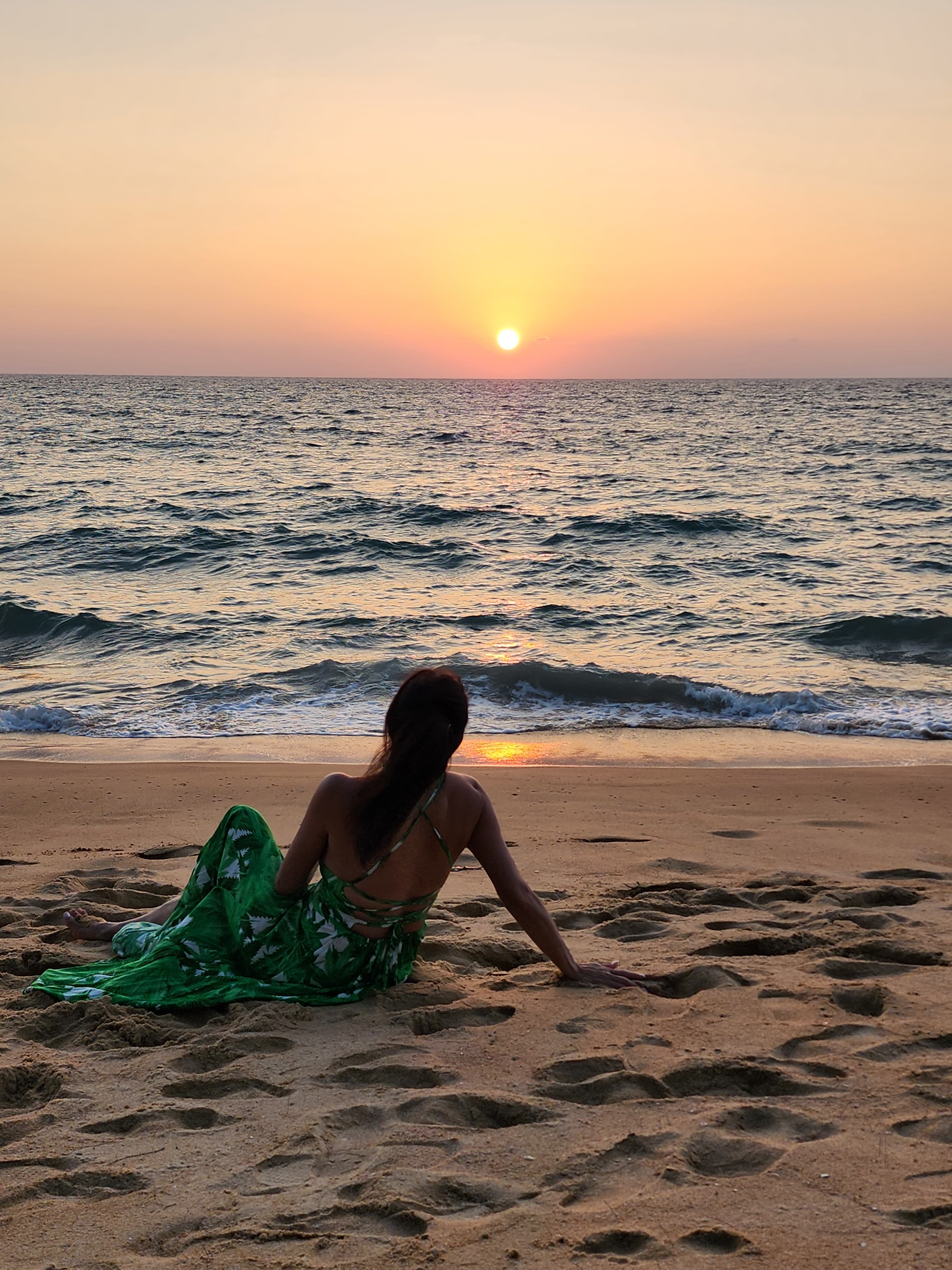 Advisor lying on the beach during sunset.