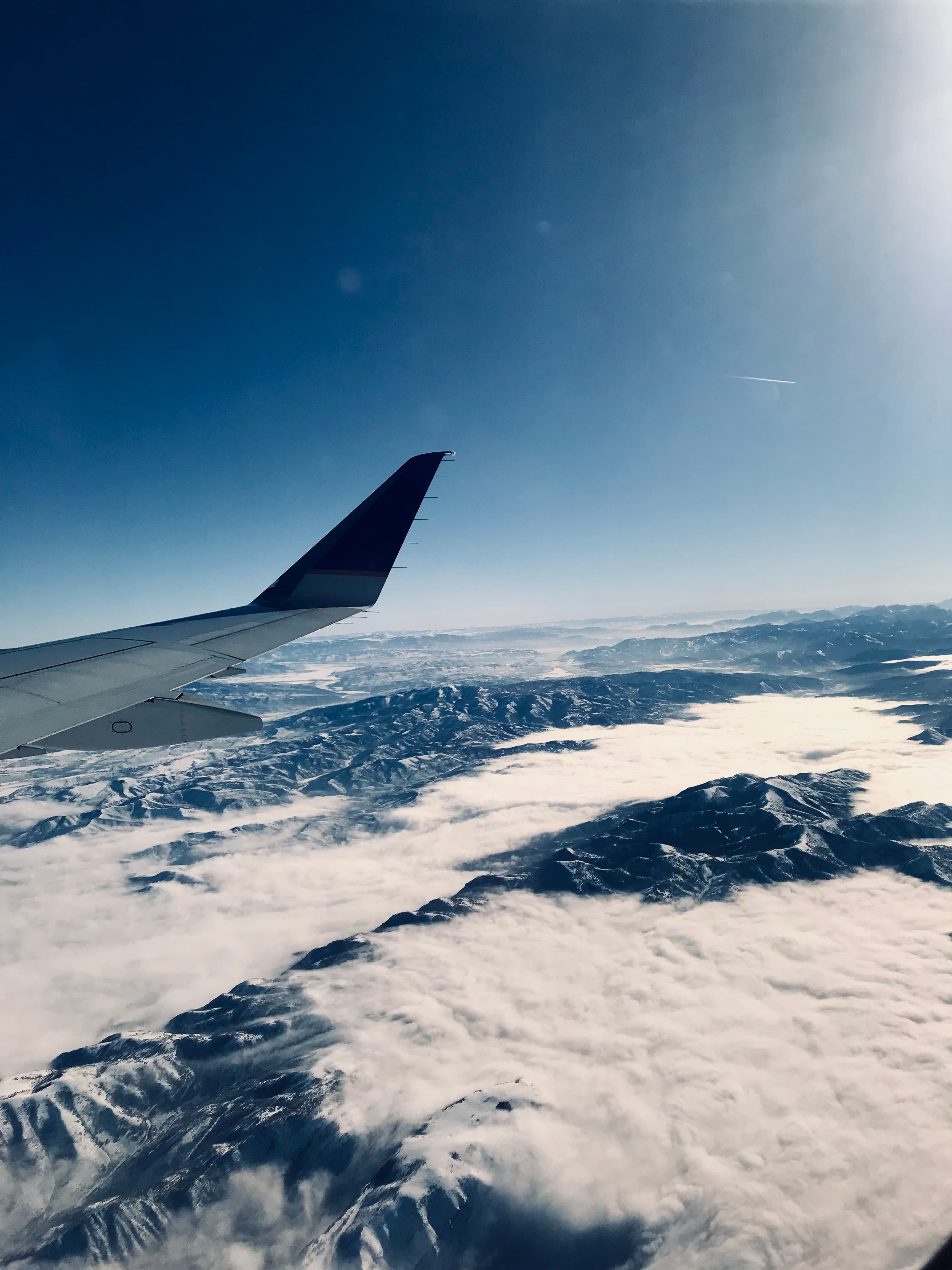 View of a snow-covered landscape from the window of a plane
