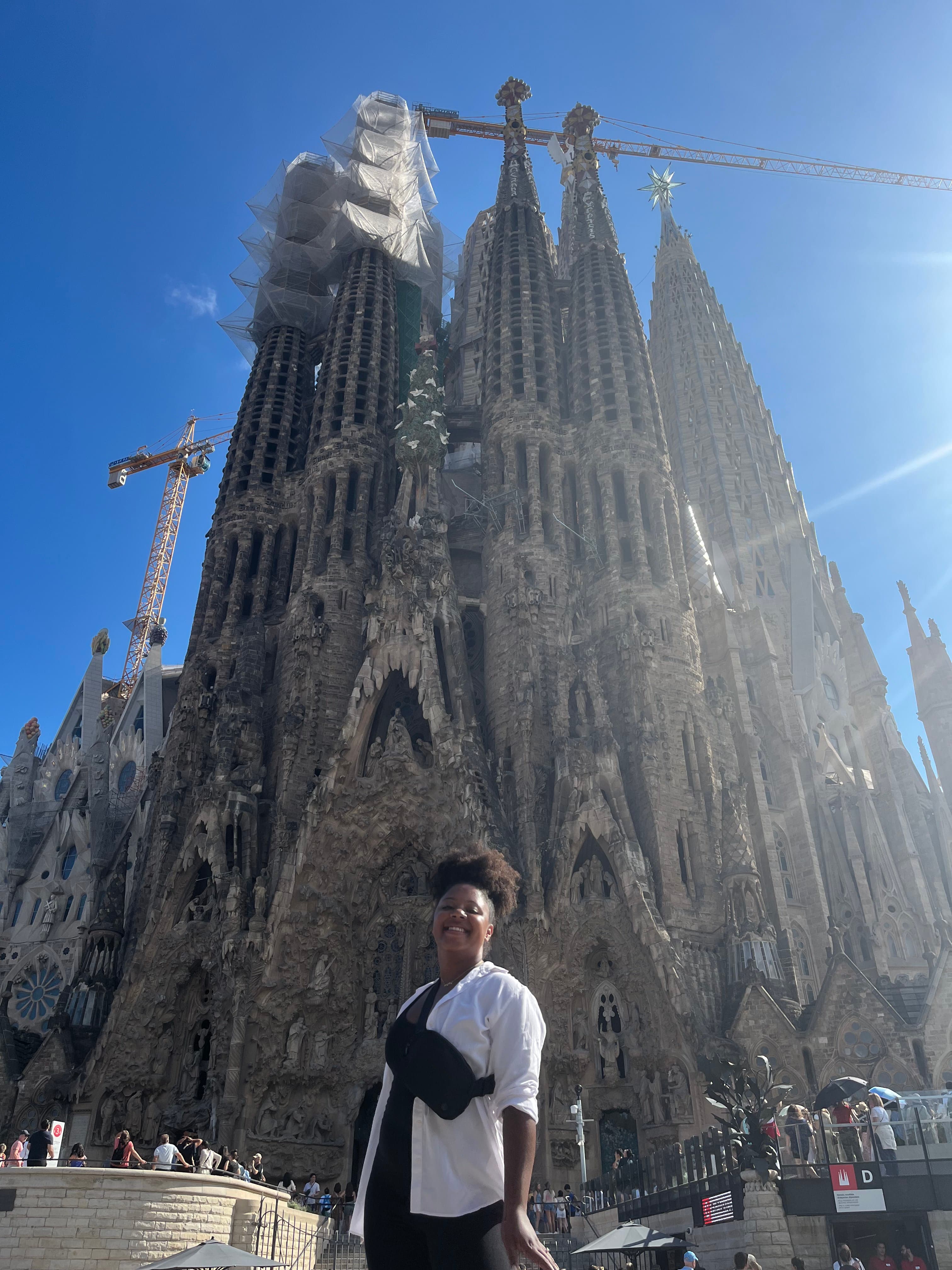 Advisor posing in front of a large tall building during the daytime.