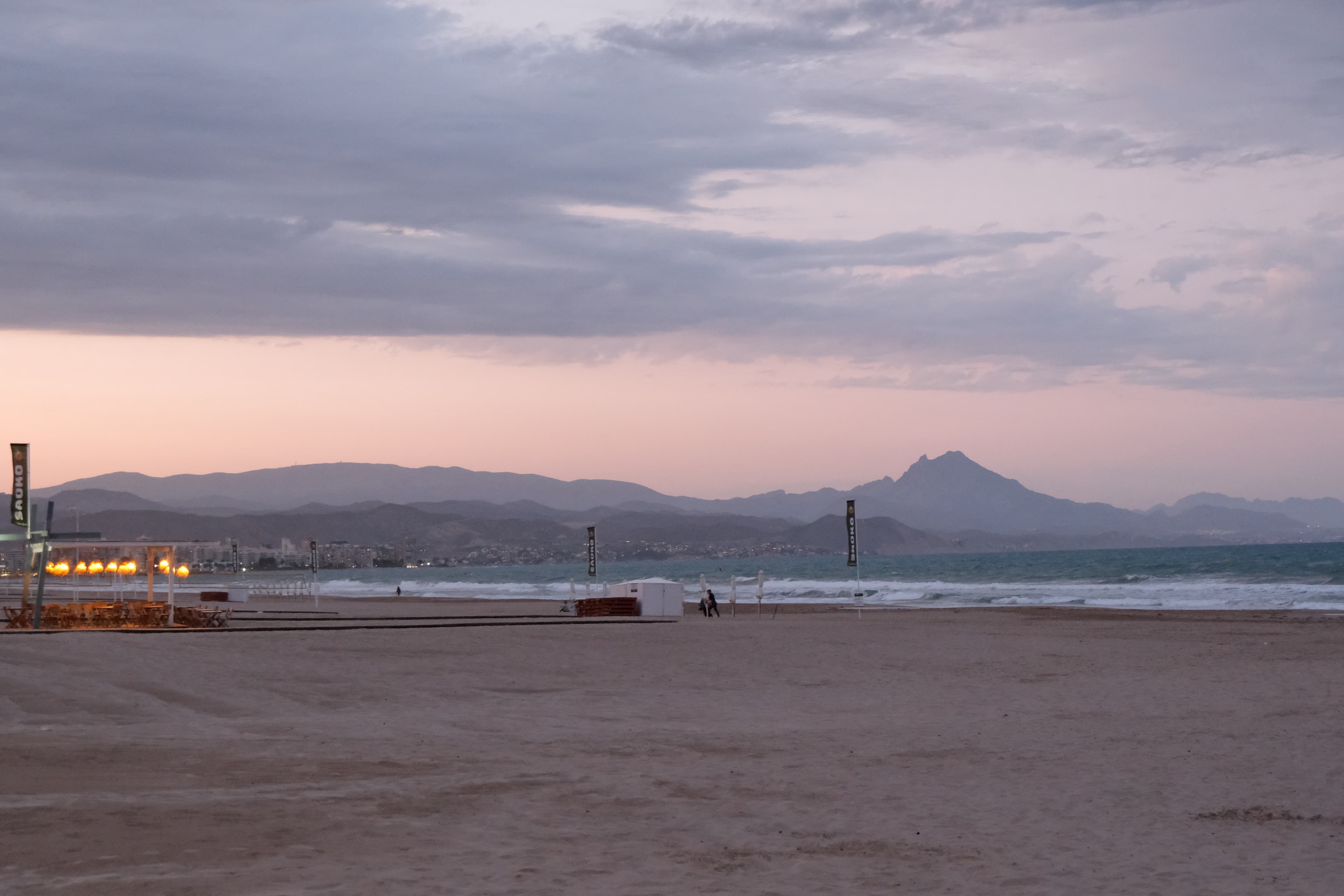 A beach with mountains in the background.