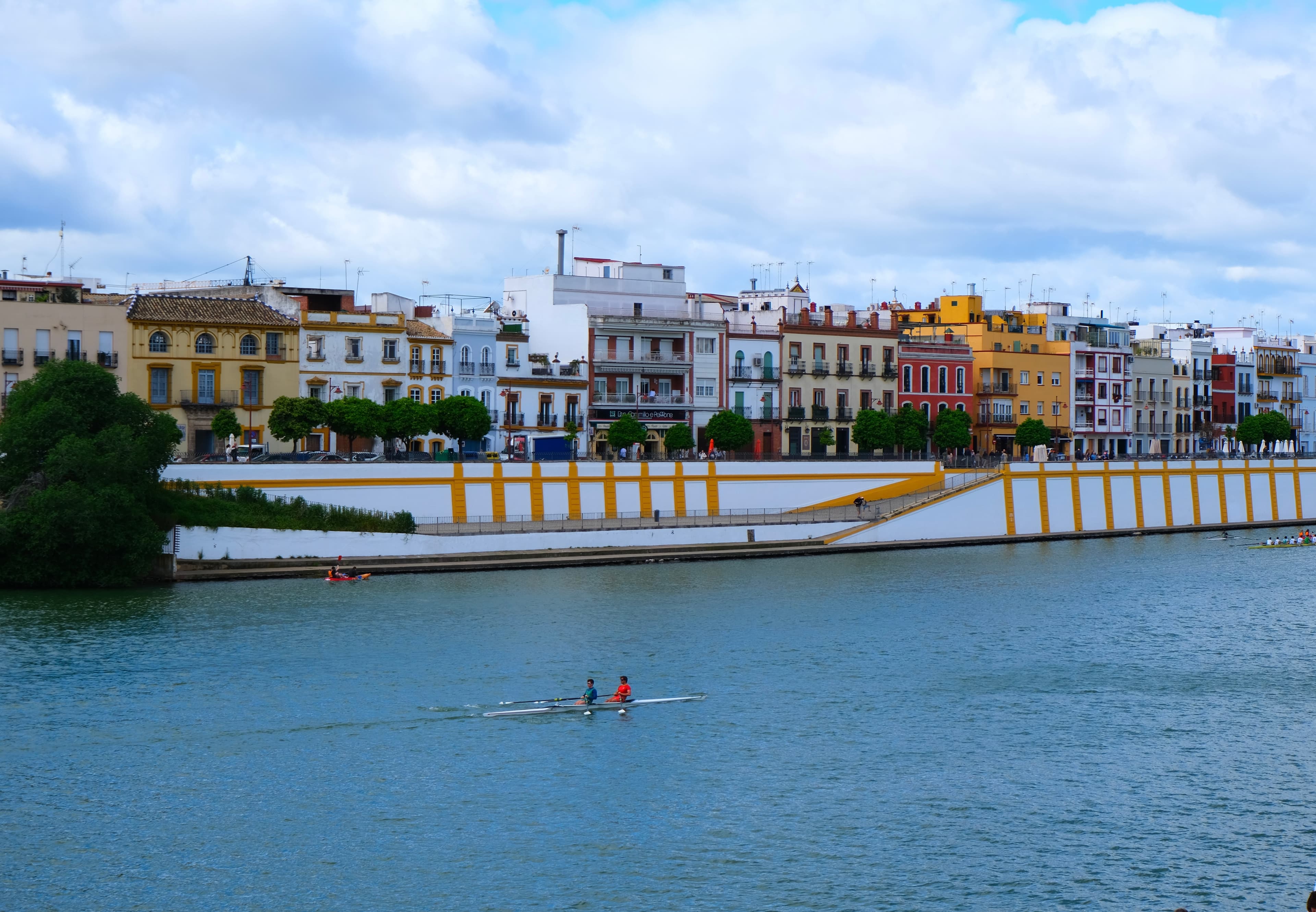  Scenic river with boats and colorful buildings in the background.