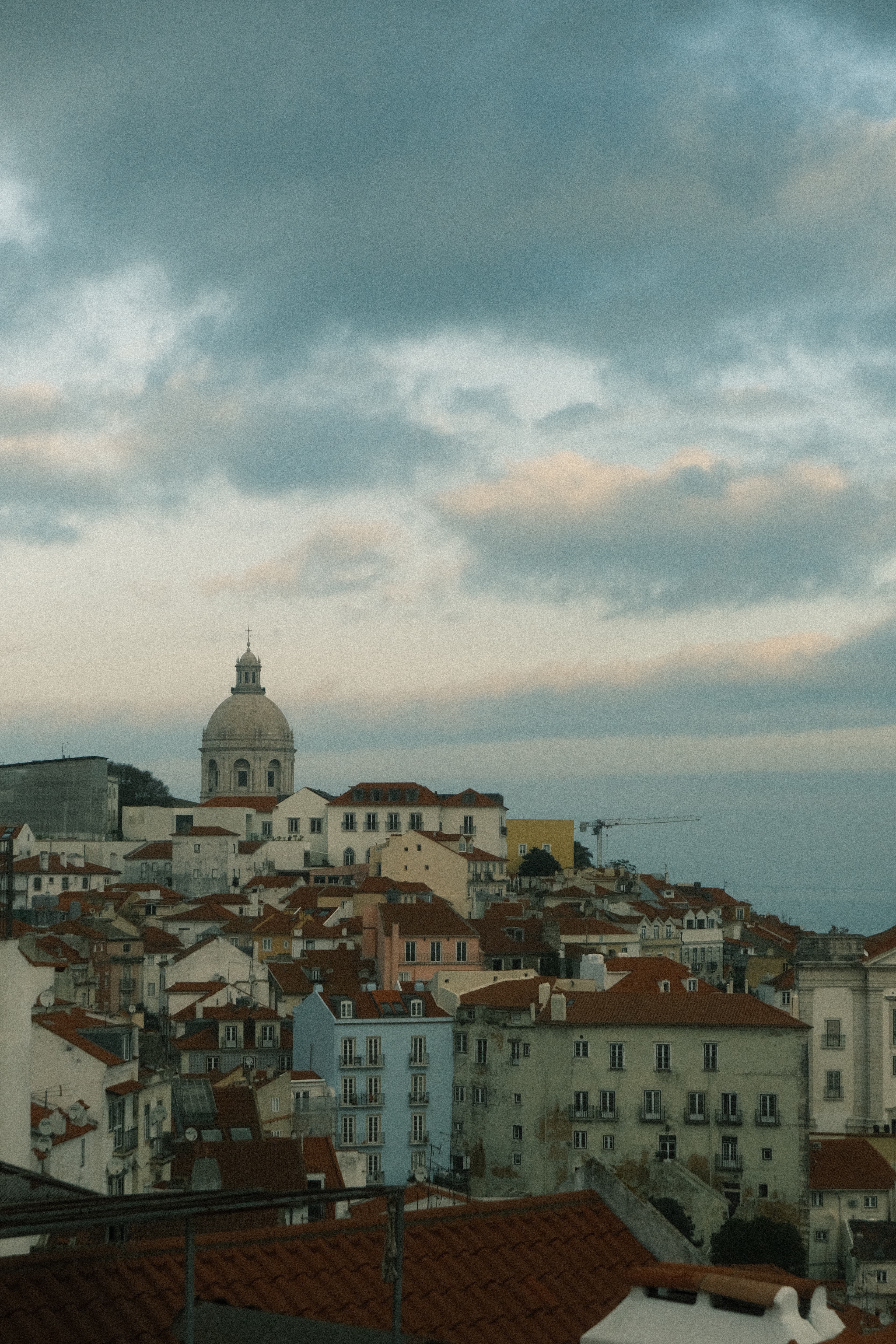 Aerial view of a bustling cityscape with numerous tall buildings and busy streets below.