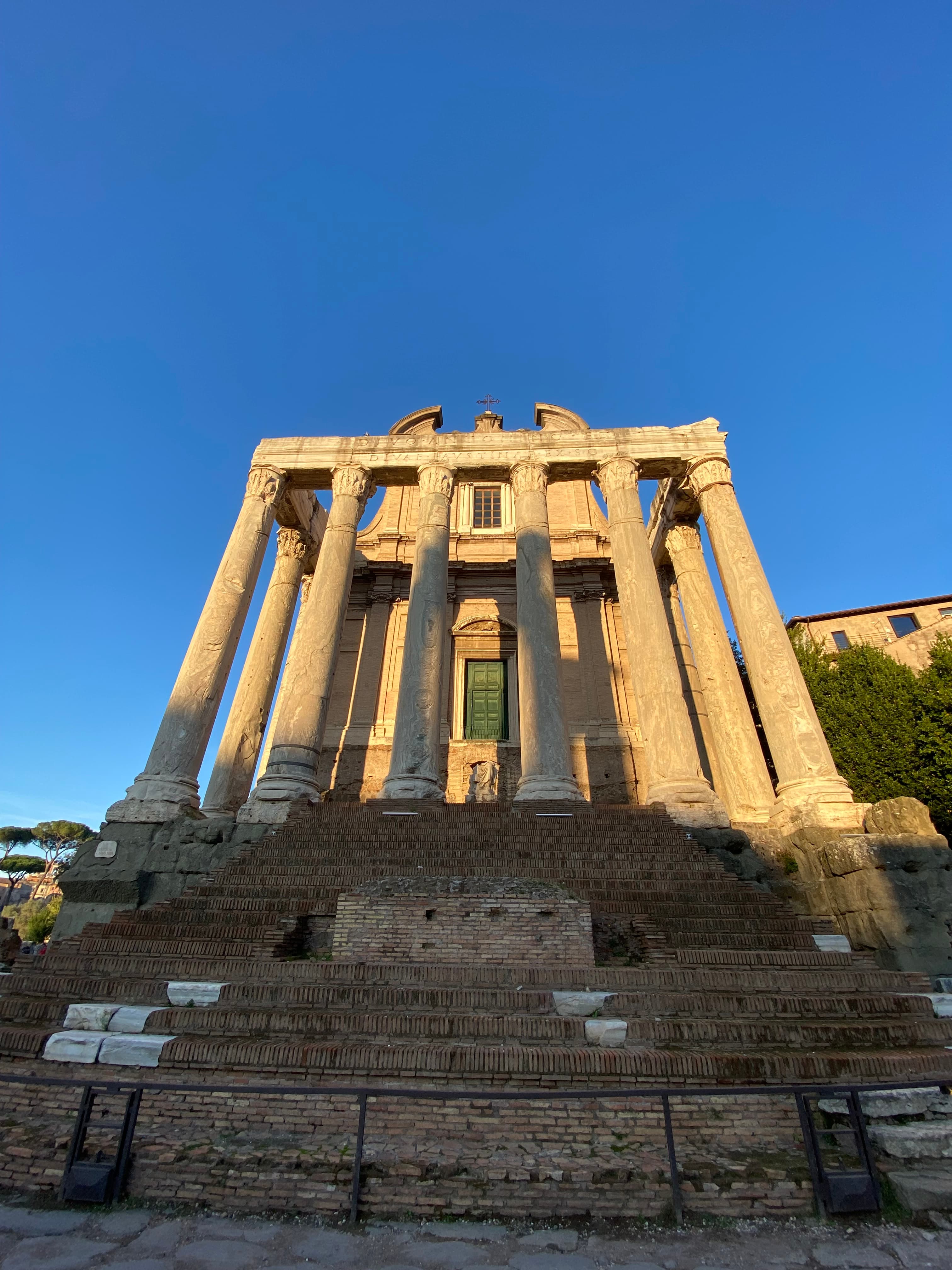 Image of an ancient building with columns at sunset. 