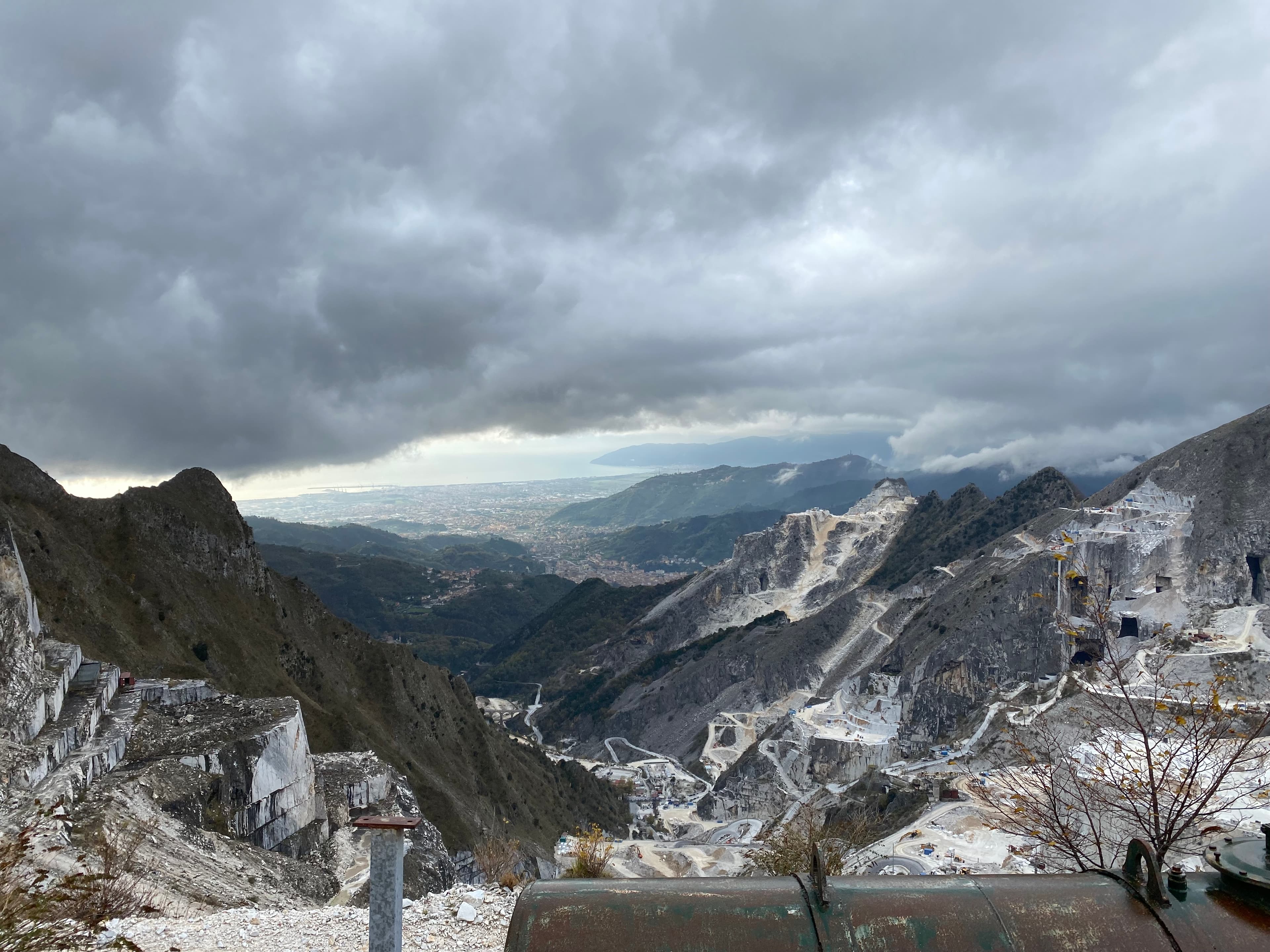 View of a valley with snow on a cloudy day. 