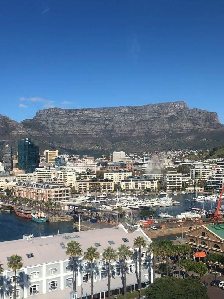 Panoramic cityscape from hotel's top floor, overlooking the skyline and surrounding buildings.