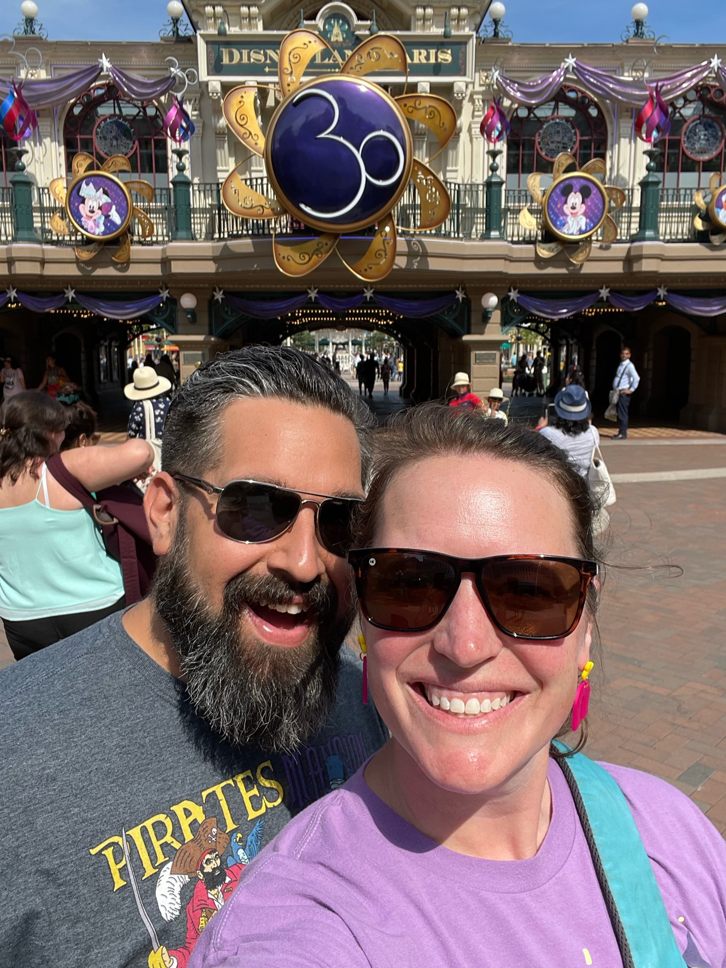 Beth and her partner wearing sunglasses and taking a selfie at Disney World 