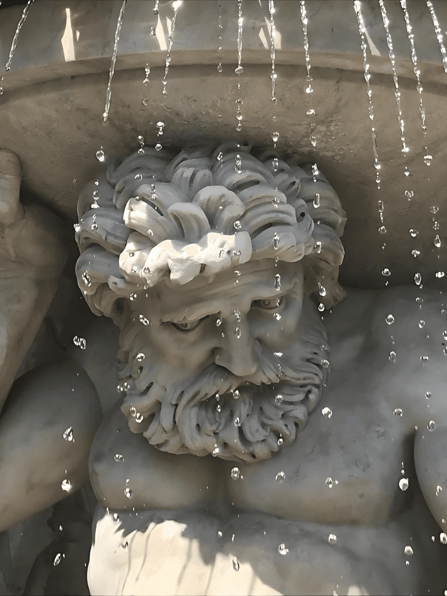 Close up image of the sculpture of a man carved into a fountain