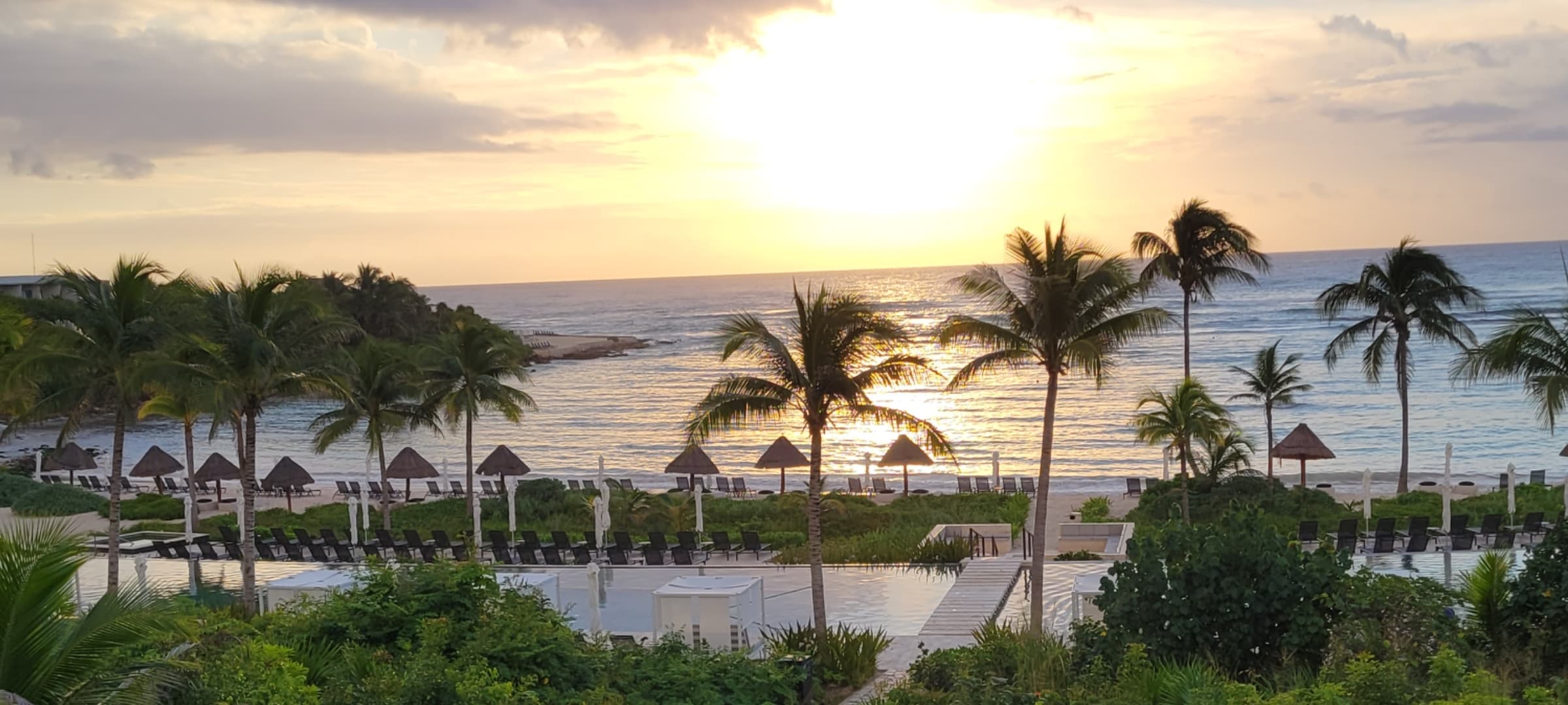 View of a Tulum resort overlooking the ocean at sunset