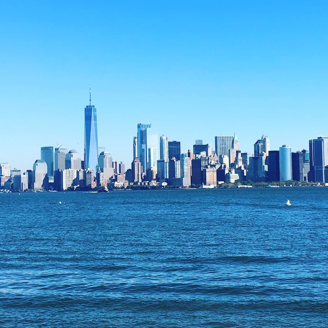 Skyscrapers over water and blue skies.