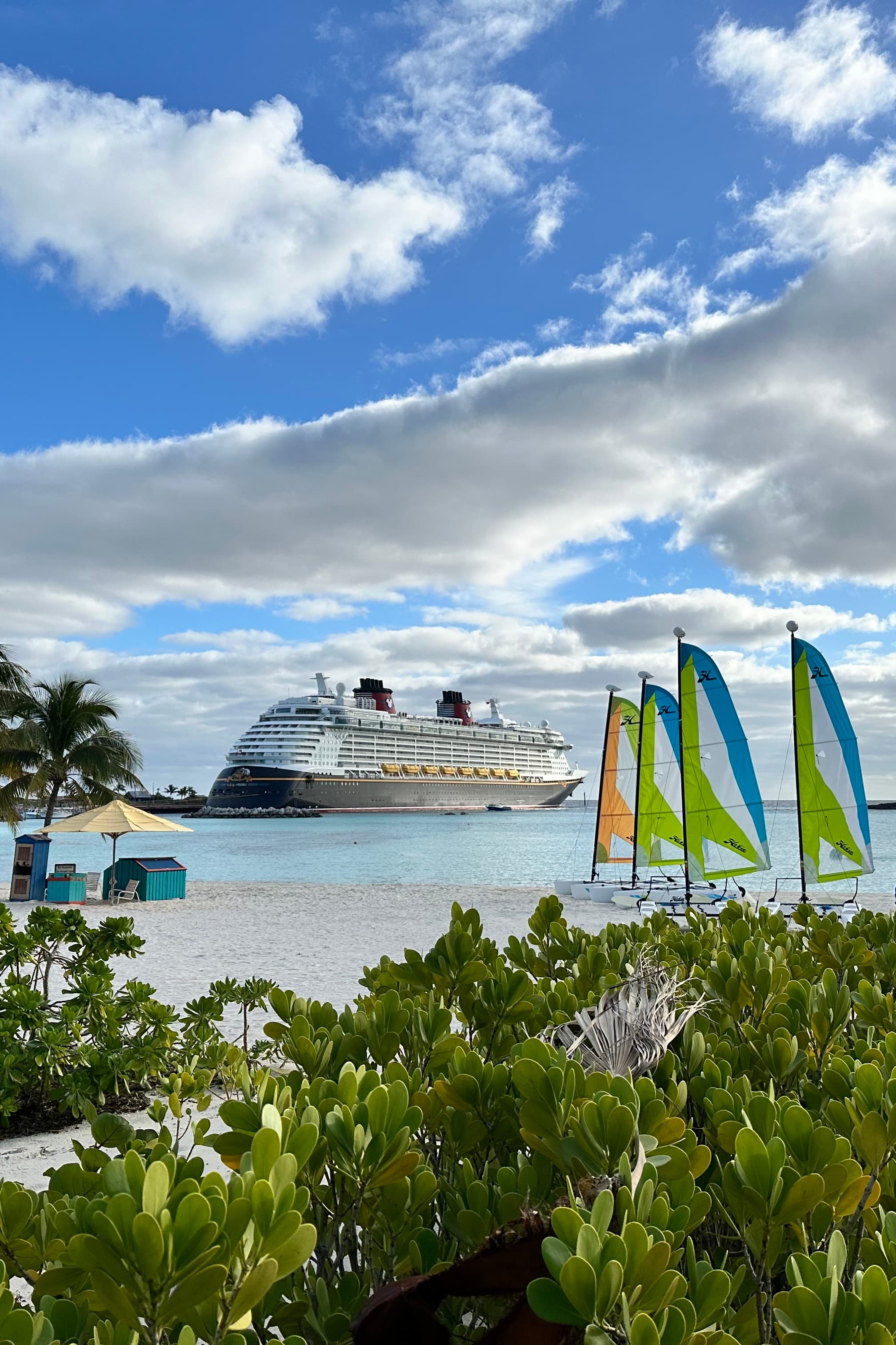 A view of a cruise ship in the ocean on a sunny day. 