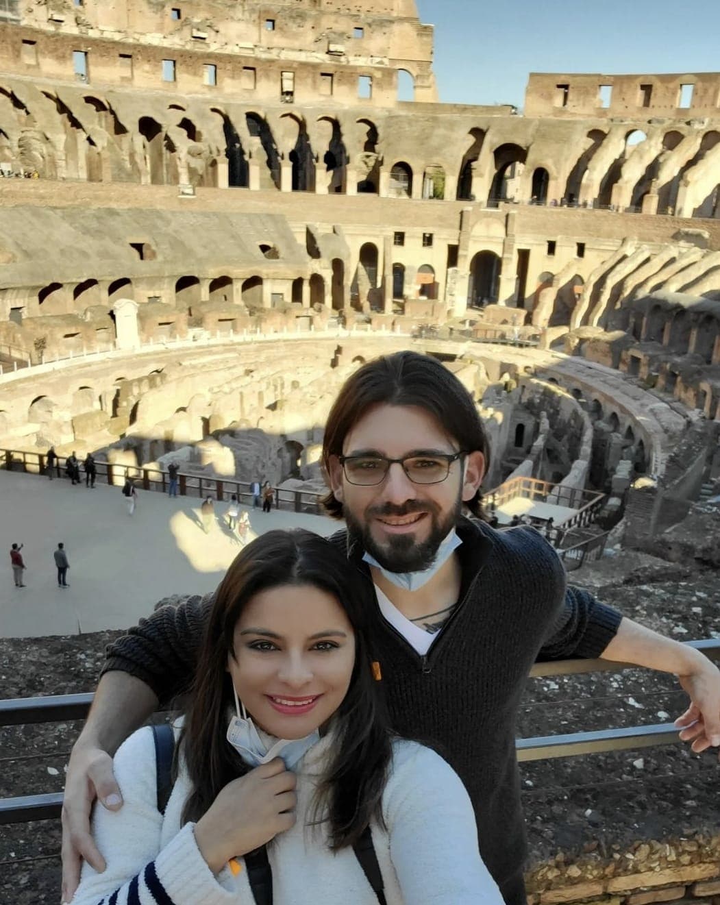 Advisor and her partner smiling for a photo inside the Colosseum on a sunny day